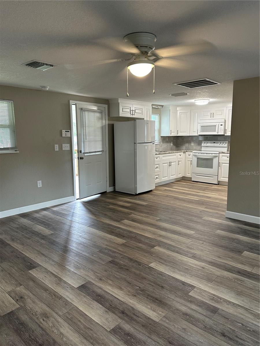 Upper unit living room looking into kitchen