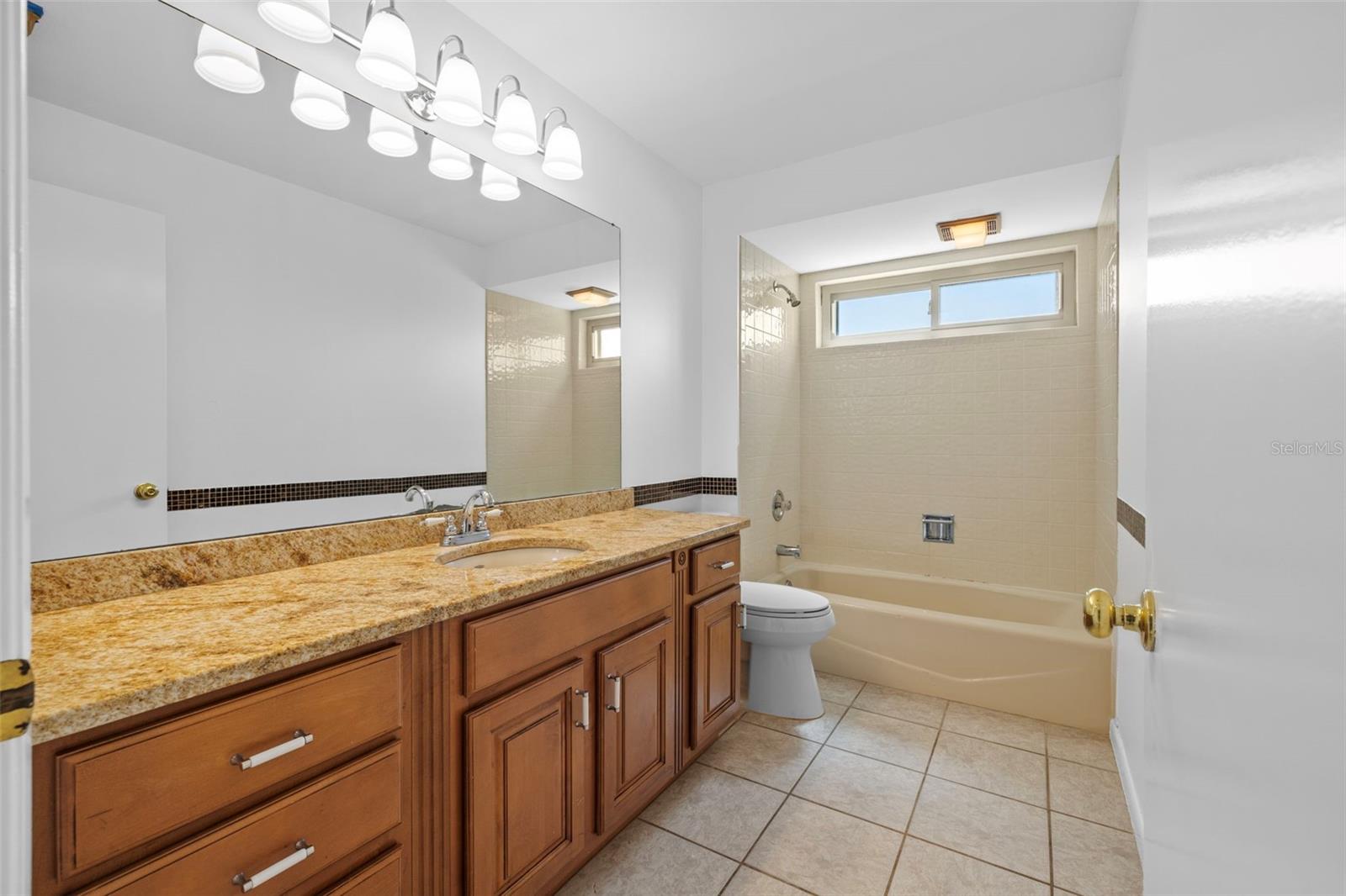 Full bath with a shower/tub combo that the 2 guest bedrooms share