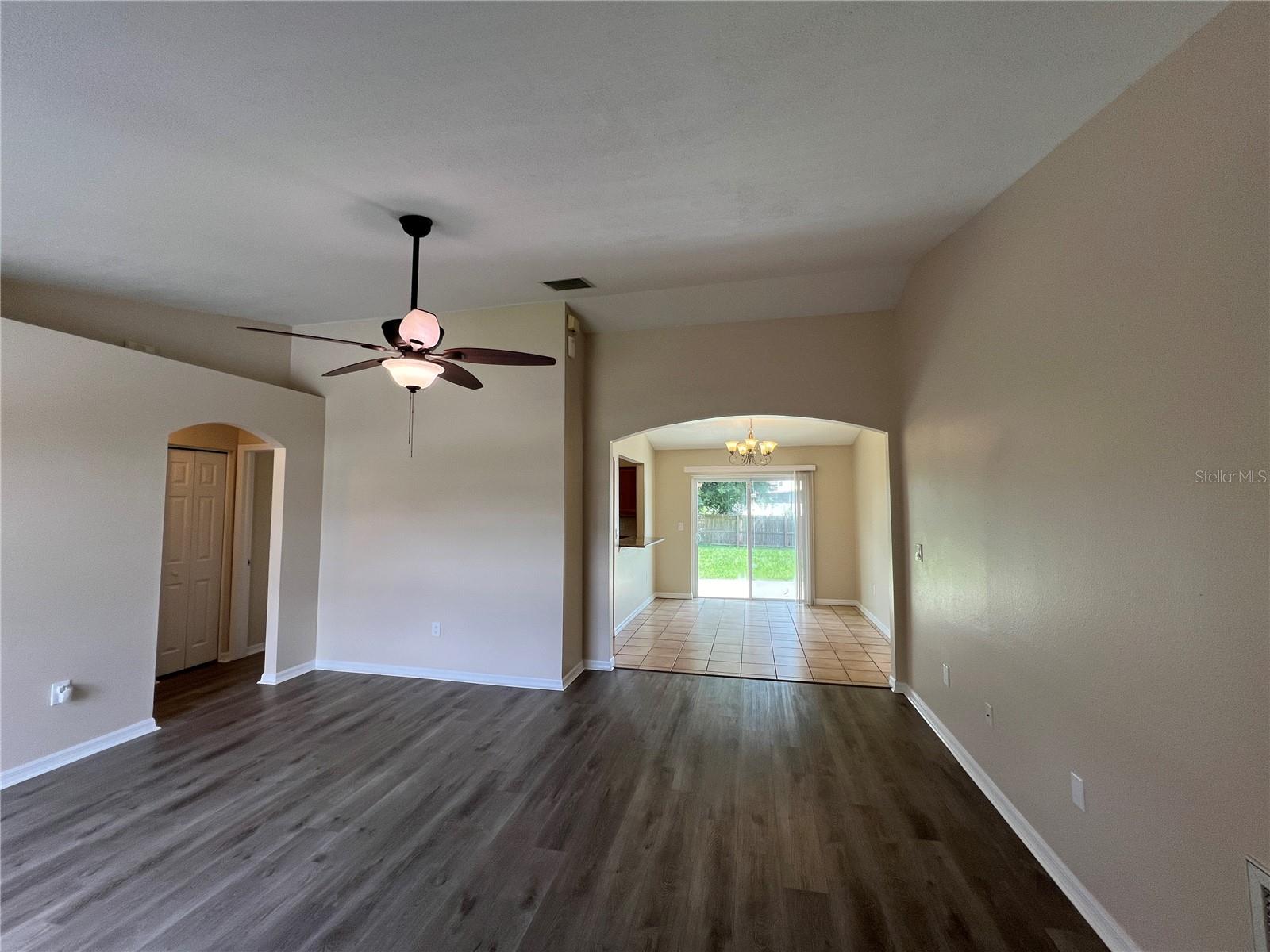 Living room view toward dining and kitchen