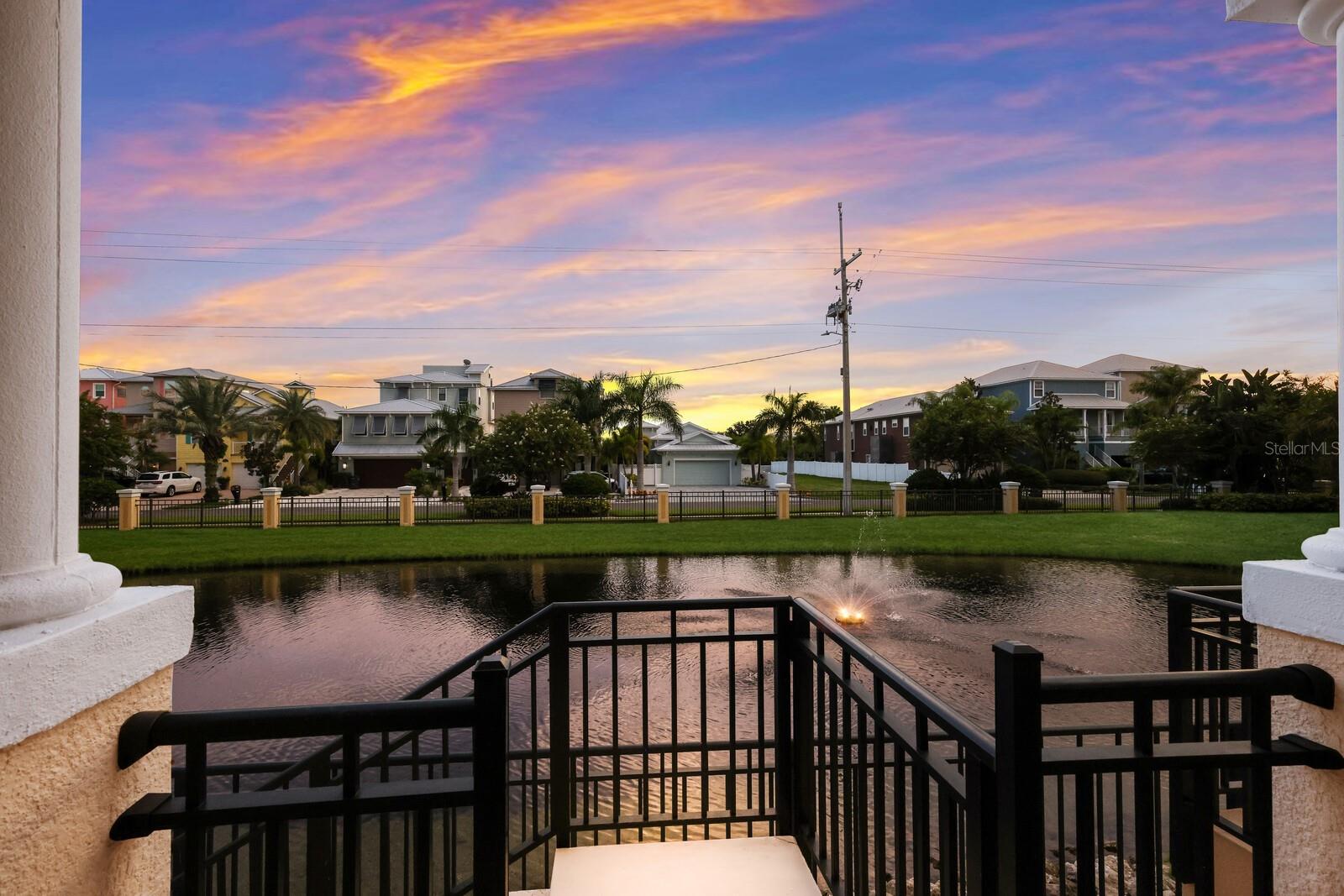 First floor balcony overlooking pond and walk down to main level