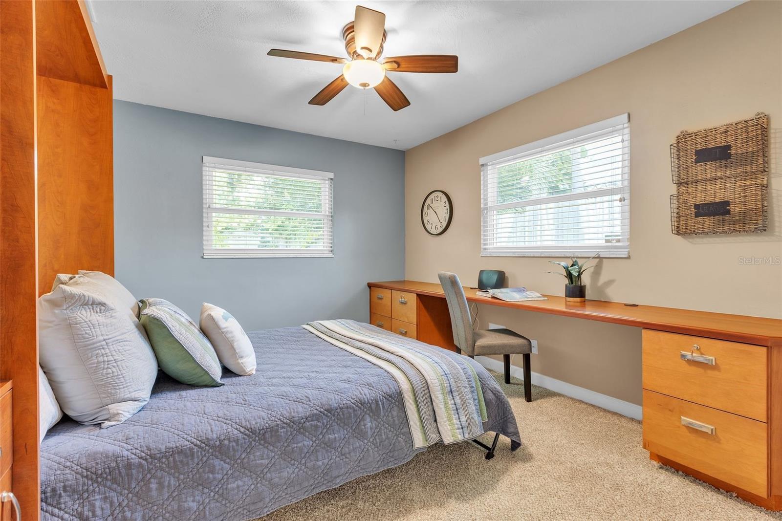 2nd bedroom with Murphy bed and built in desk that convey