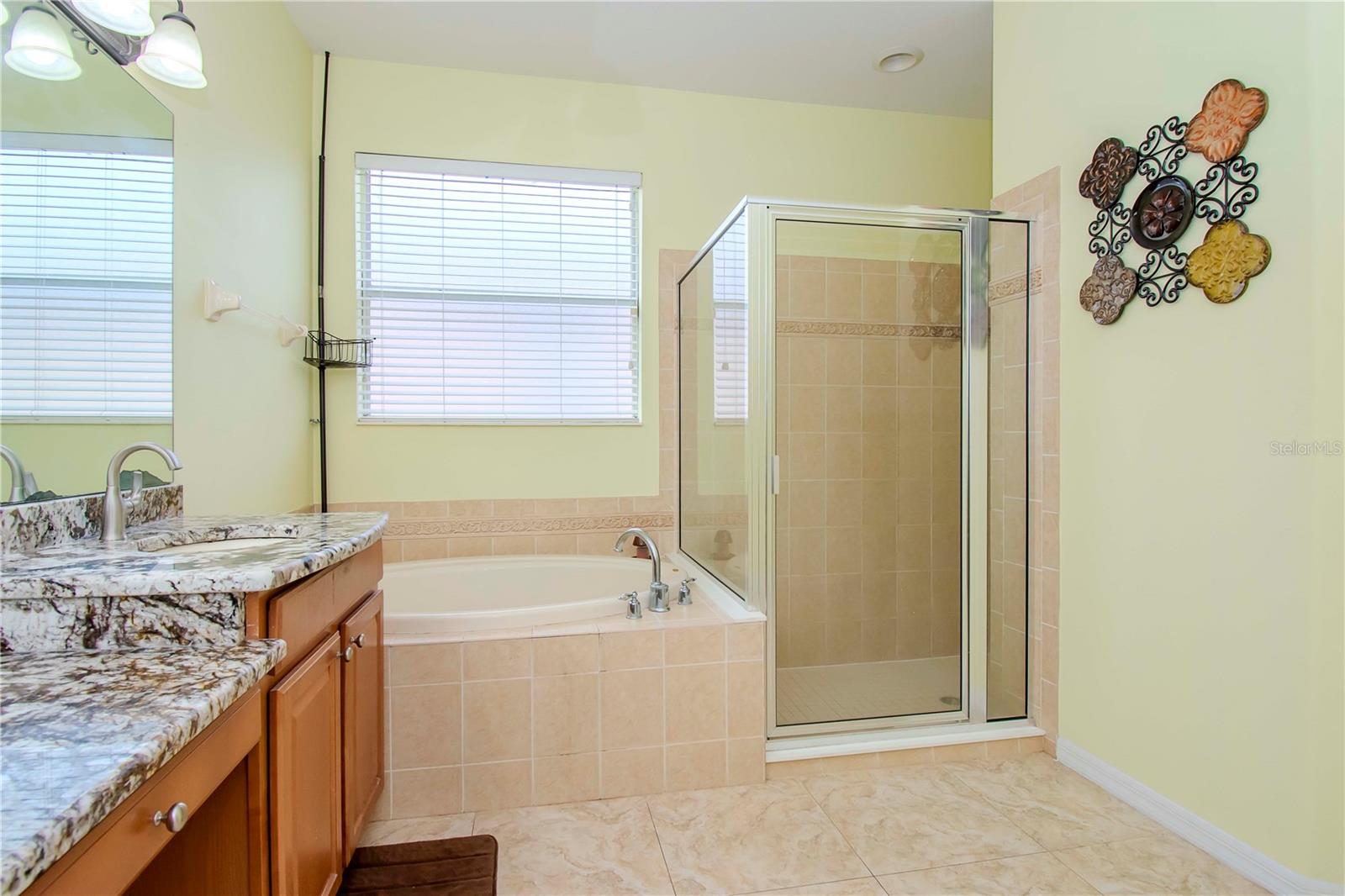 Spacious shower stall, bath and double vanities