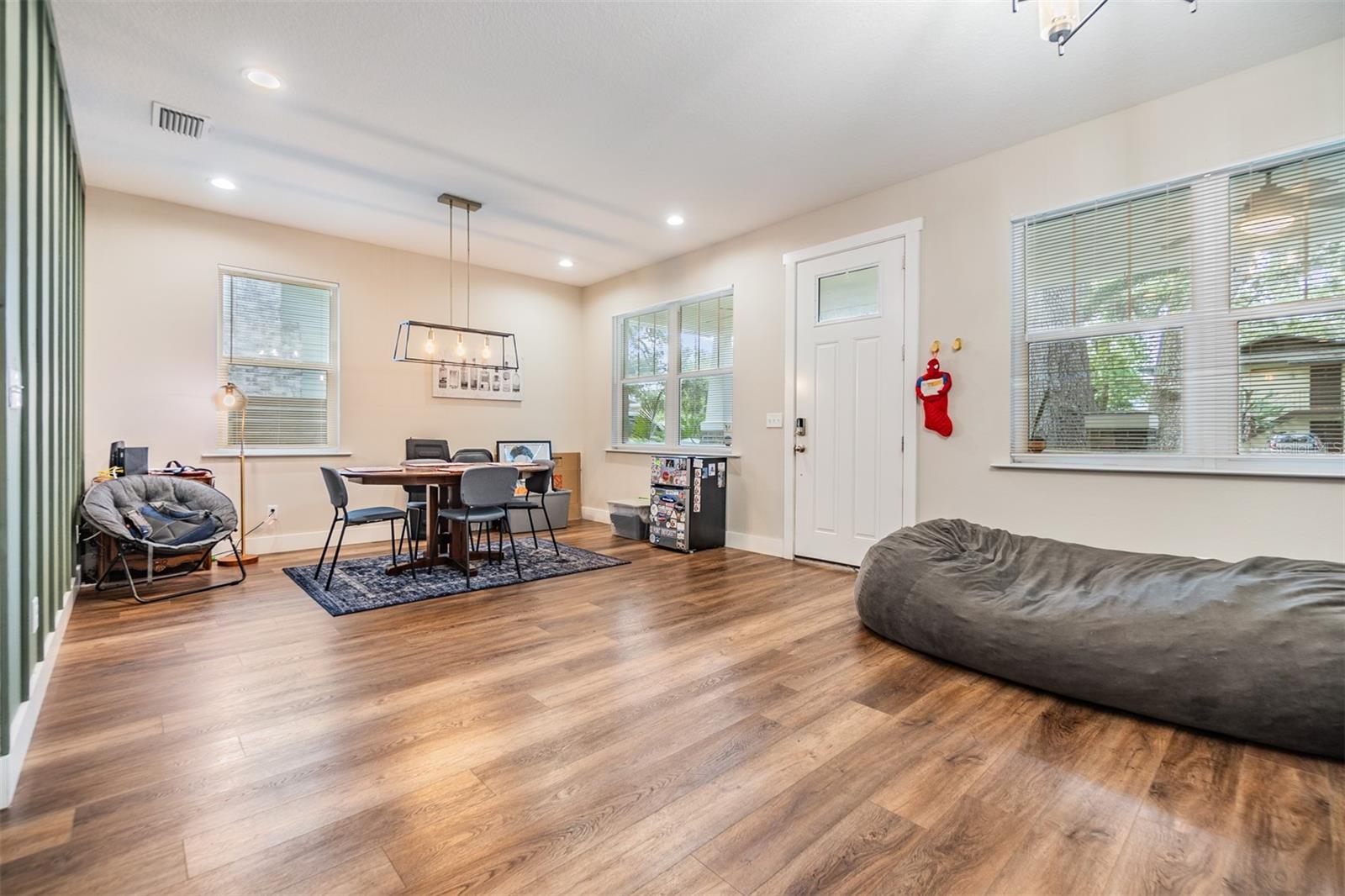 Formal living room/Dining Room, updated flooring and accent wall with inset lighting.