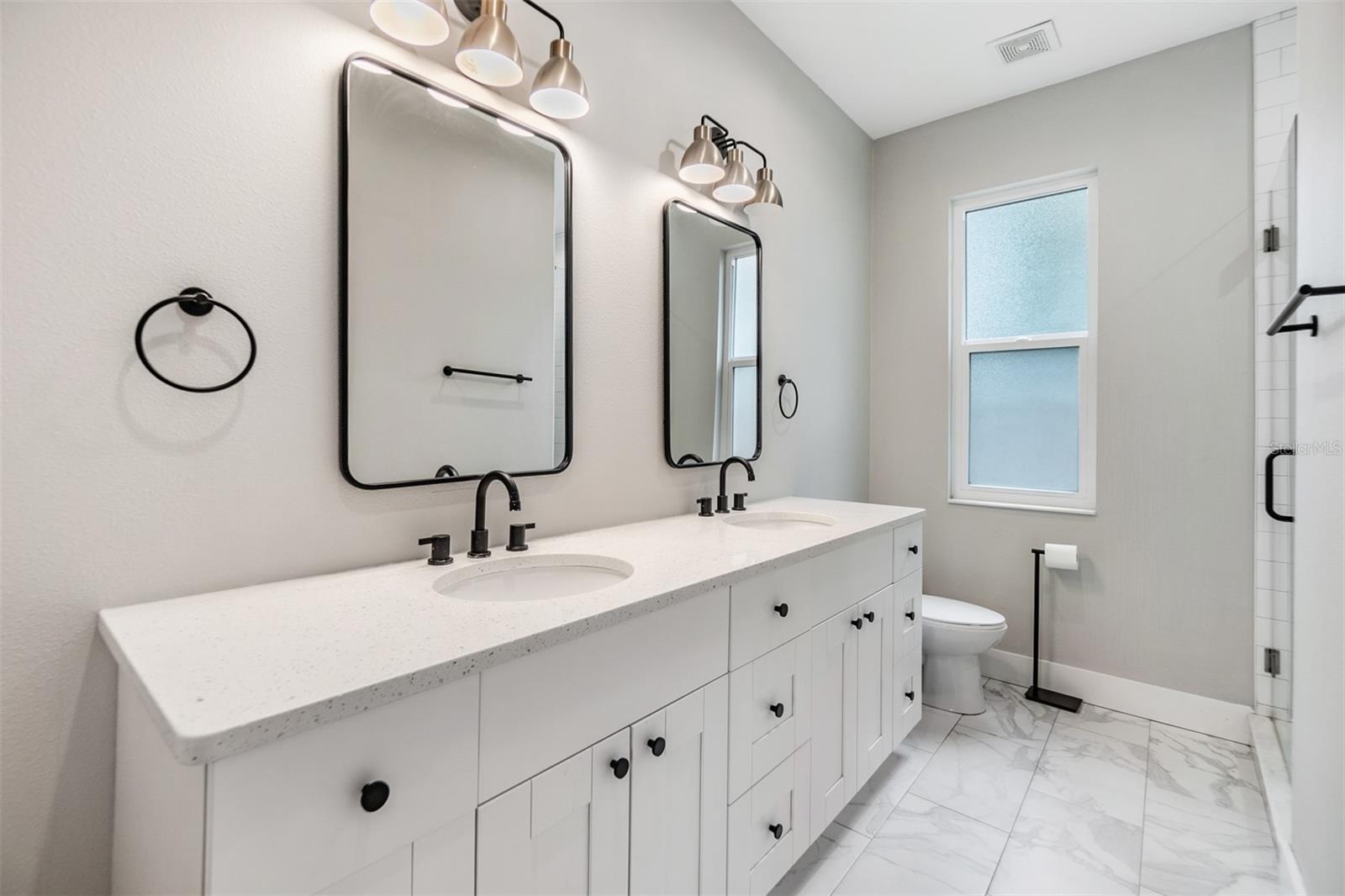 Master bathroom, double bathroom with updated fixtures and tile flooring.