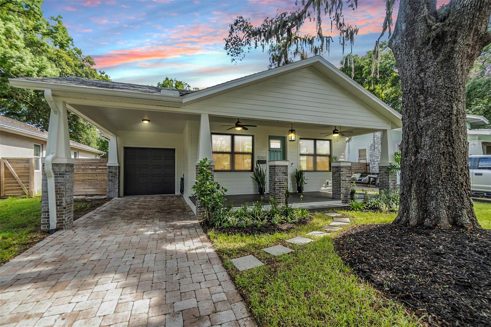 Front Exterior - Carport and garage, pavered driveway.