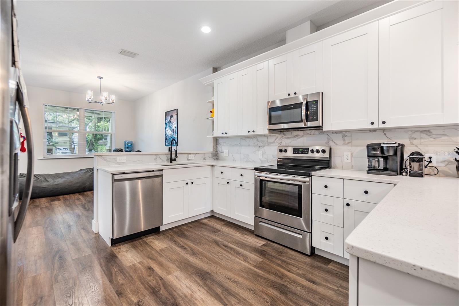 Completely updated kitchen with stainless steel appliances, open to the family room, quartz countertops.