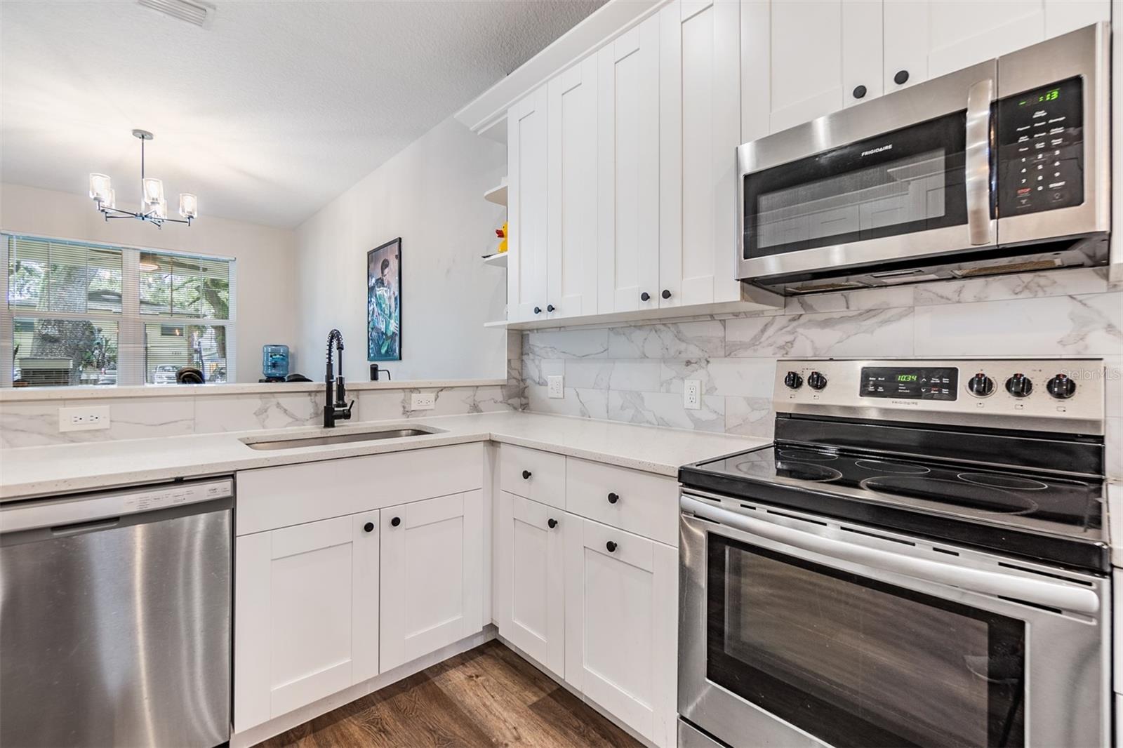 Completely updated kitchen with stainless steel appliances, open to the family room, quartz countertops.