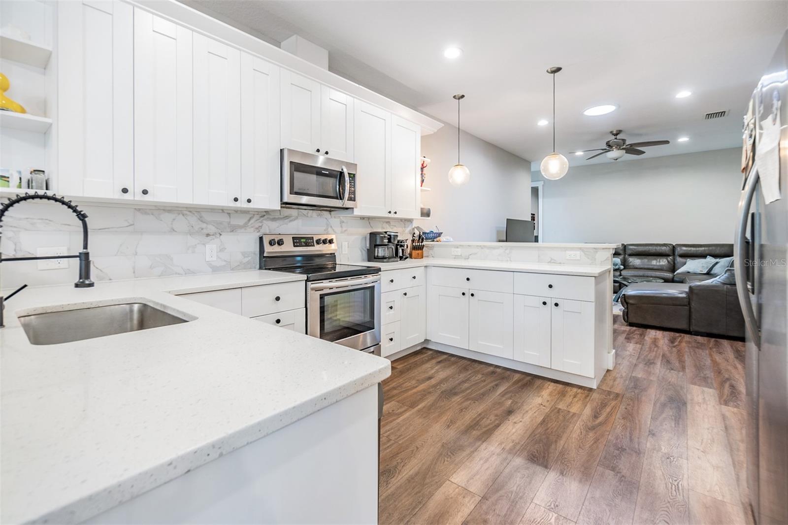 Completely updated kitchen with stainless steel appliances, open to the family room, quartz countertops.