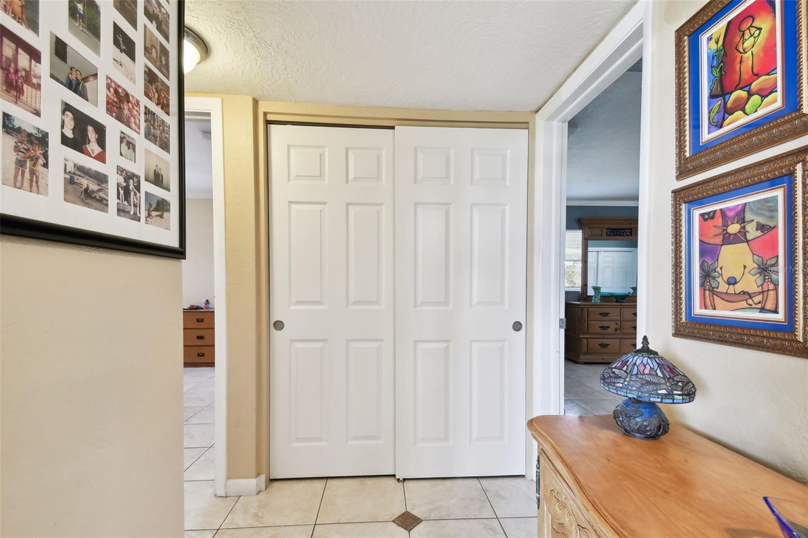 Entry hall separates 2 of the bedrooms from the living space and additional bedrooms. Split bedroom plan