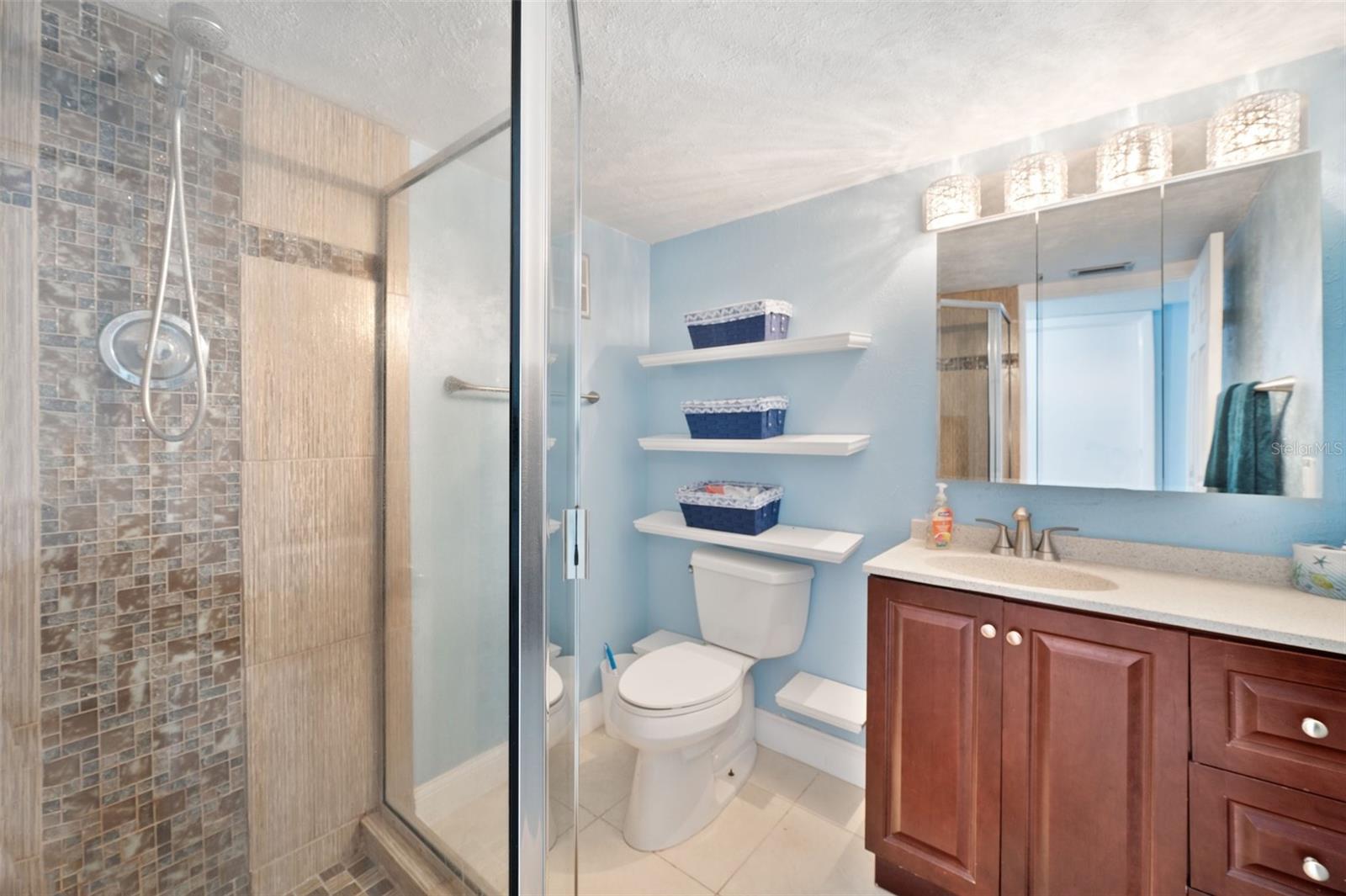 Shower stall in the guest bathroom & bath tub in the primary bathroom.