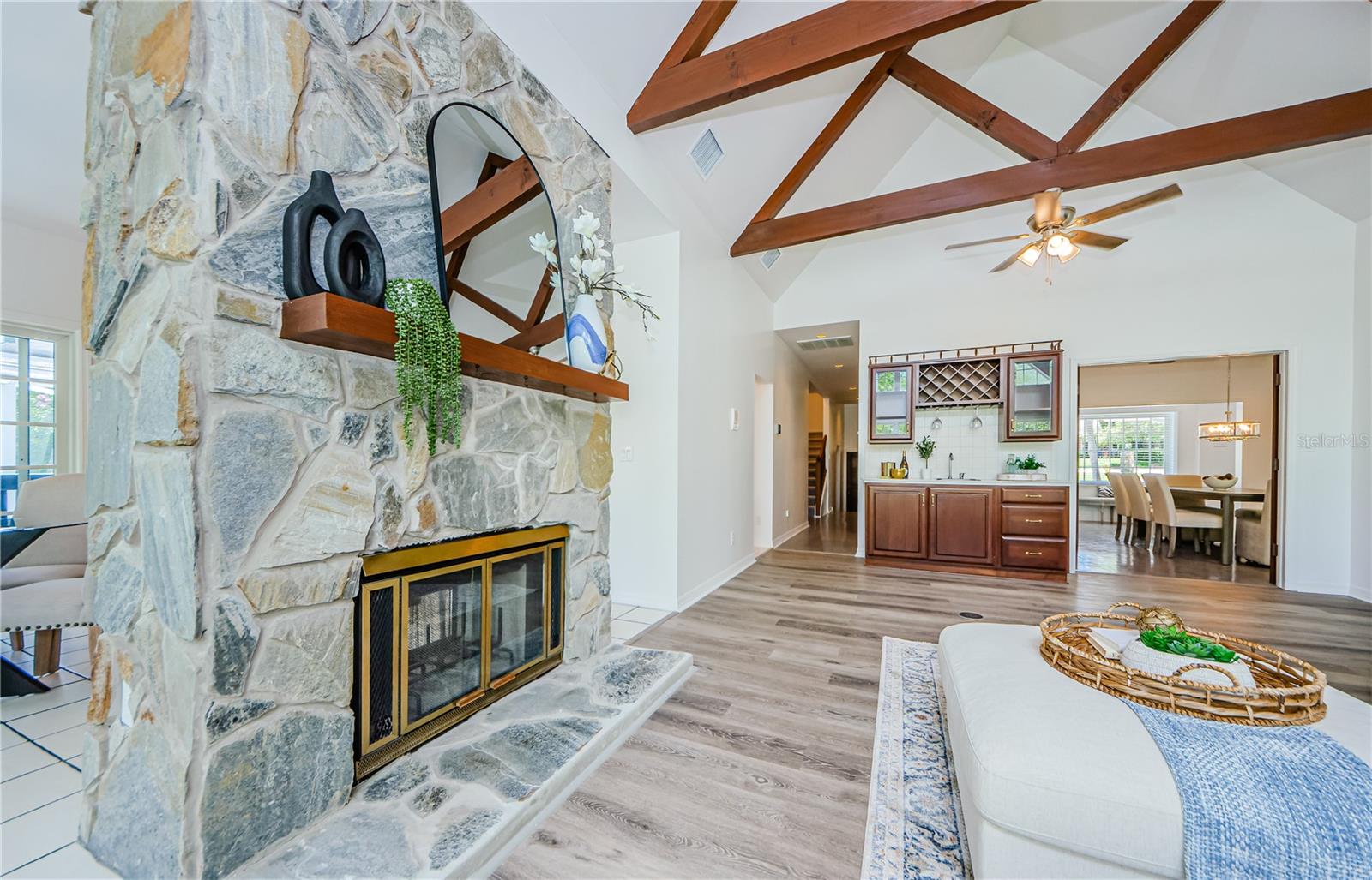 Wood burning 2 sided fireplace for family room and kitchen, with mantle.  Gorgeous cherry wood wet bar with room for all your bar accessories.