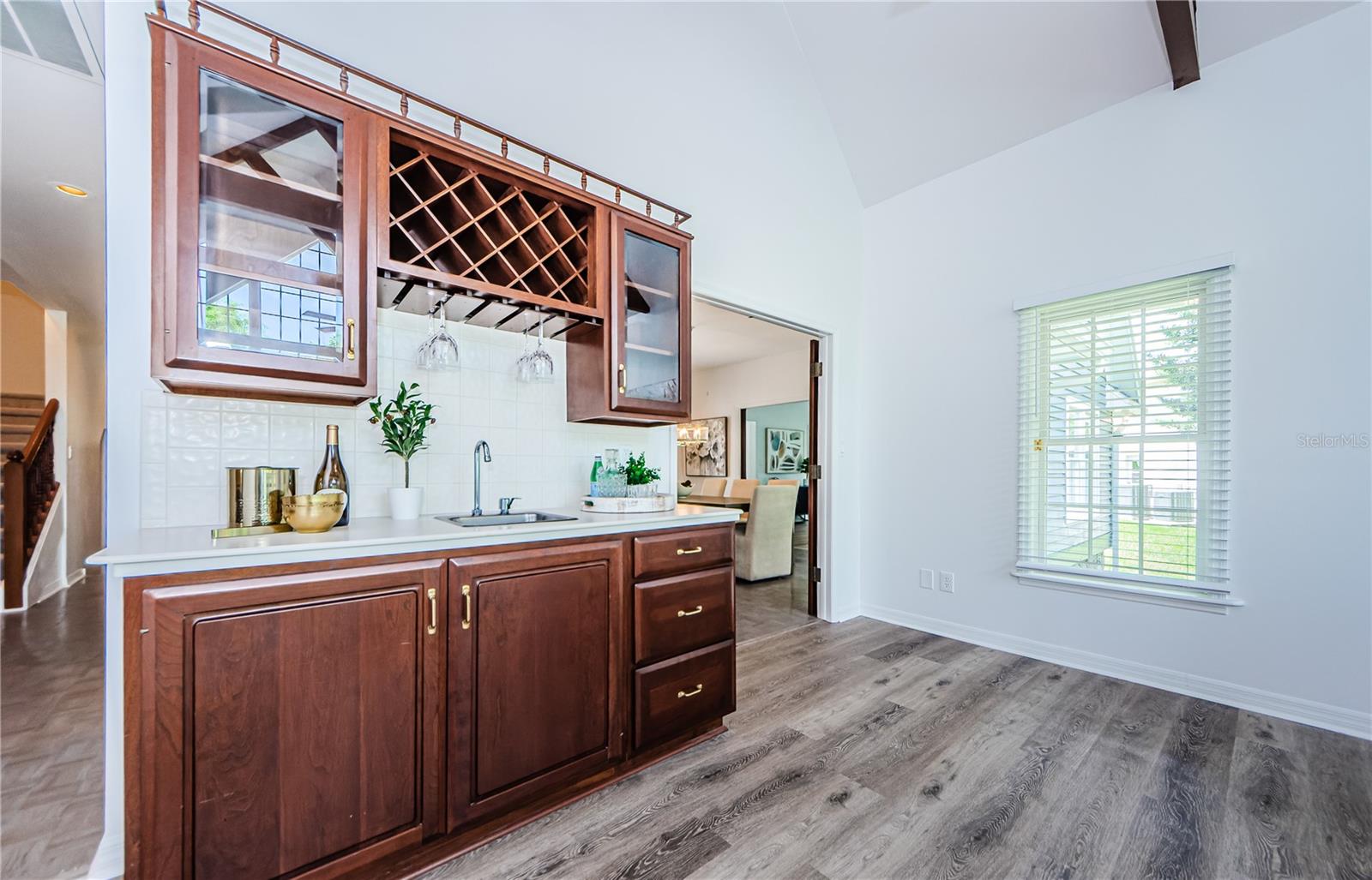 Full view of cherry wood custom made wet bar and accommodations for all you bar equipment and accessories.