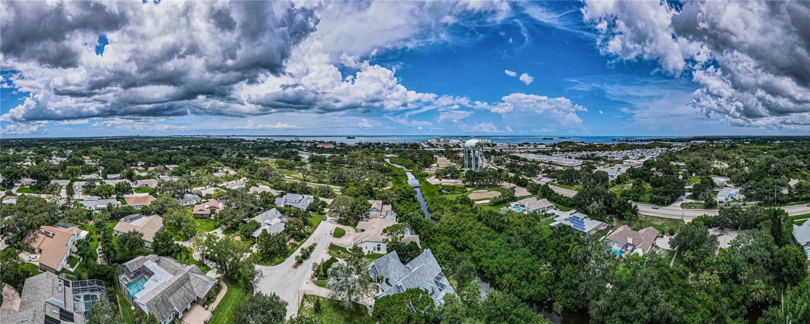 Beautiful aerial shot from home to water!  The clouds are gorgeous.