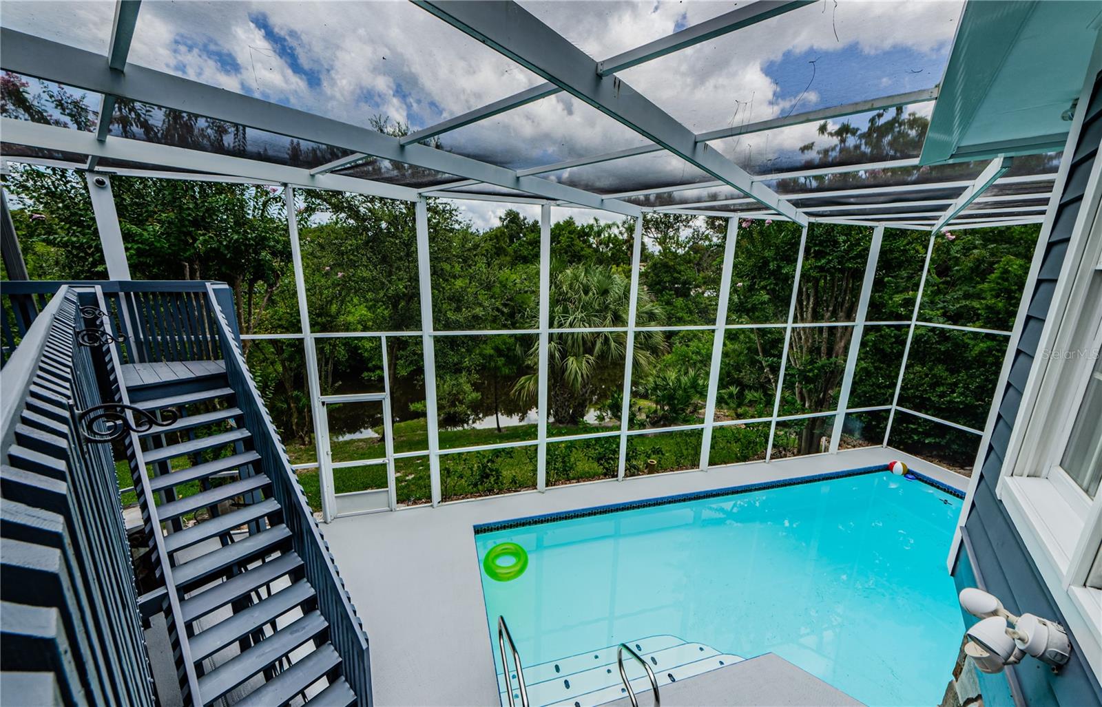 View looking down at pool with creek in the background.