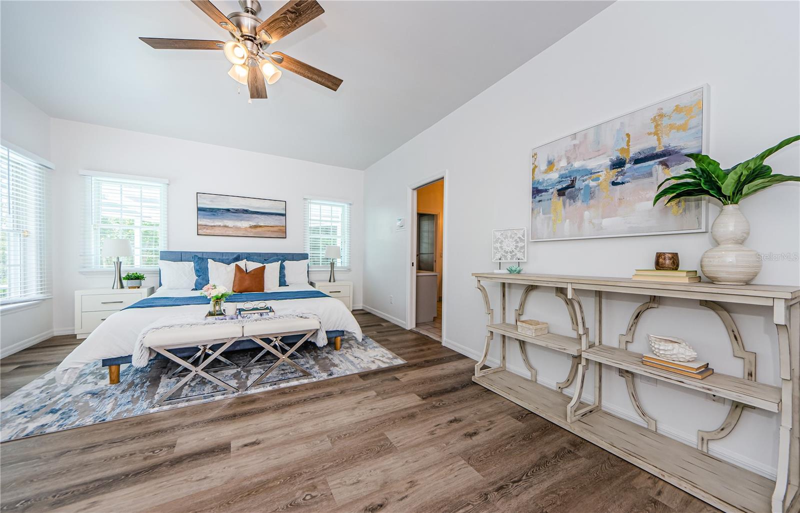 Elegant Master Ensuite with lots of windows, access to the pool, large walk-in closet, new fans, new faux blinds throughout home, and new fresh paint!