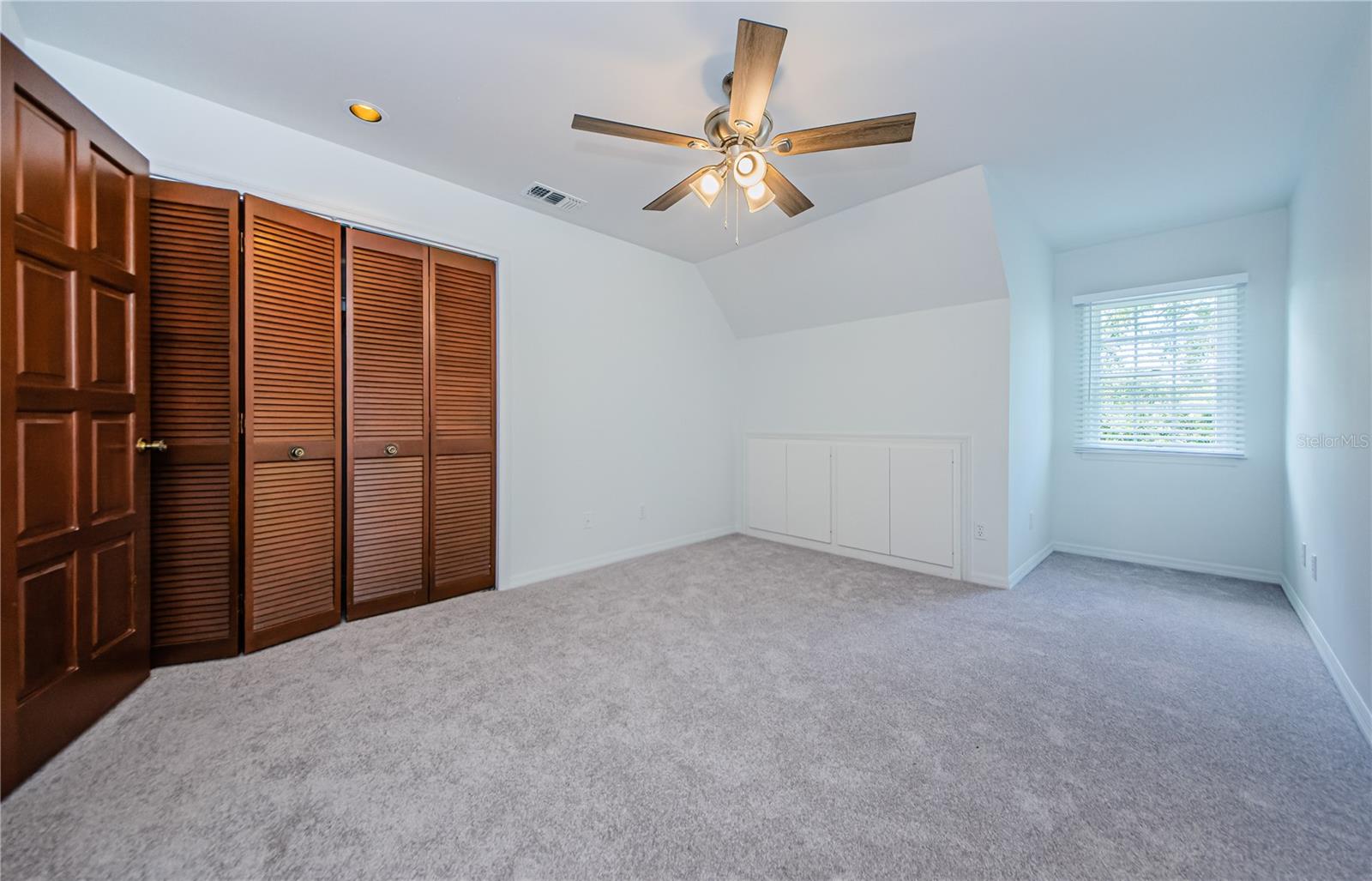 Another upper bedroom with fresh paint, new carpet, blinds, and fan.