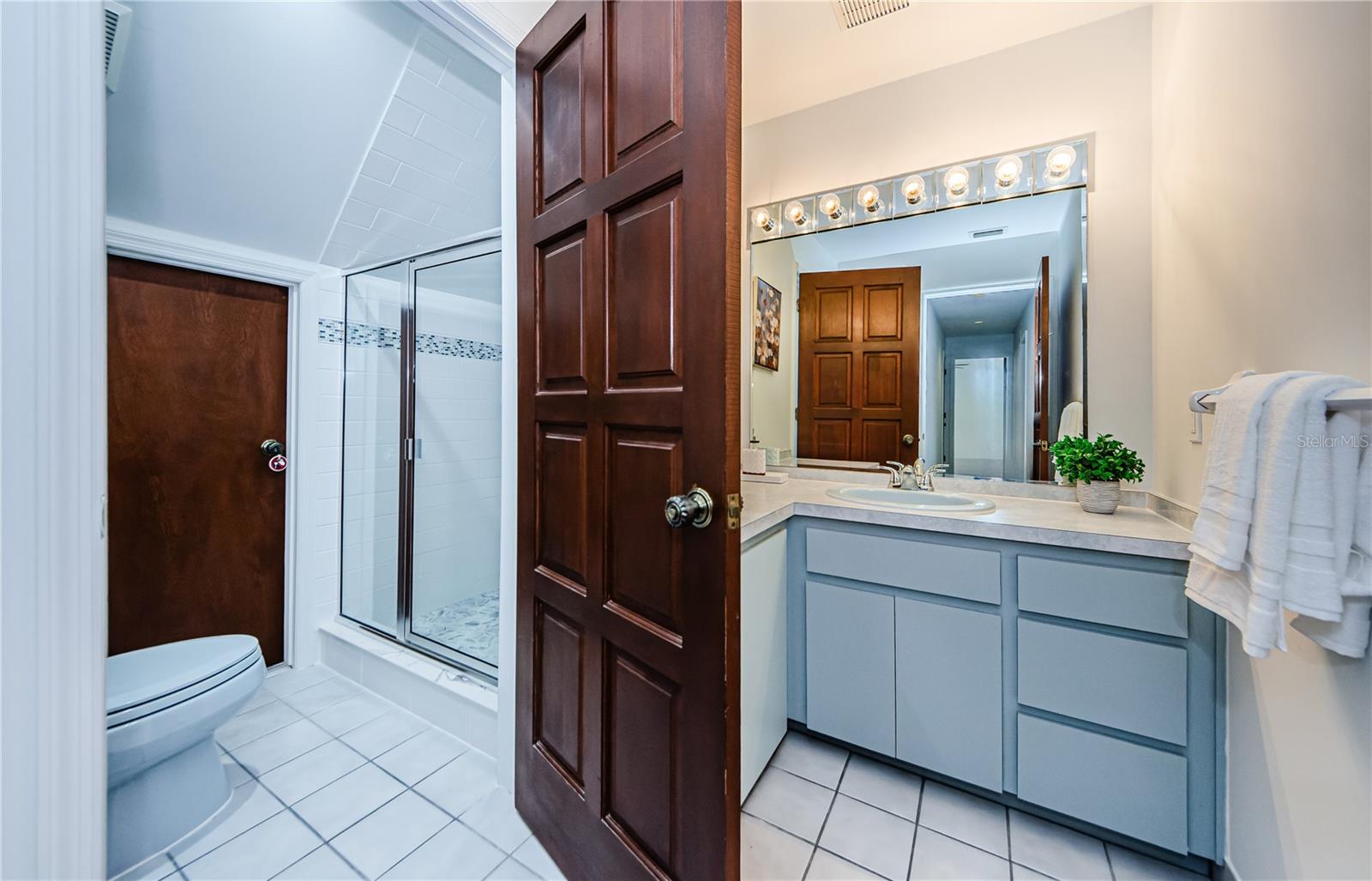 This bathroom services two of the bedrooms on the upper level.  Shower completely redone. Vanity area separate.