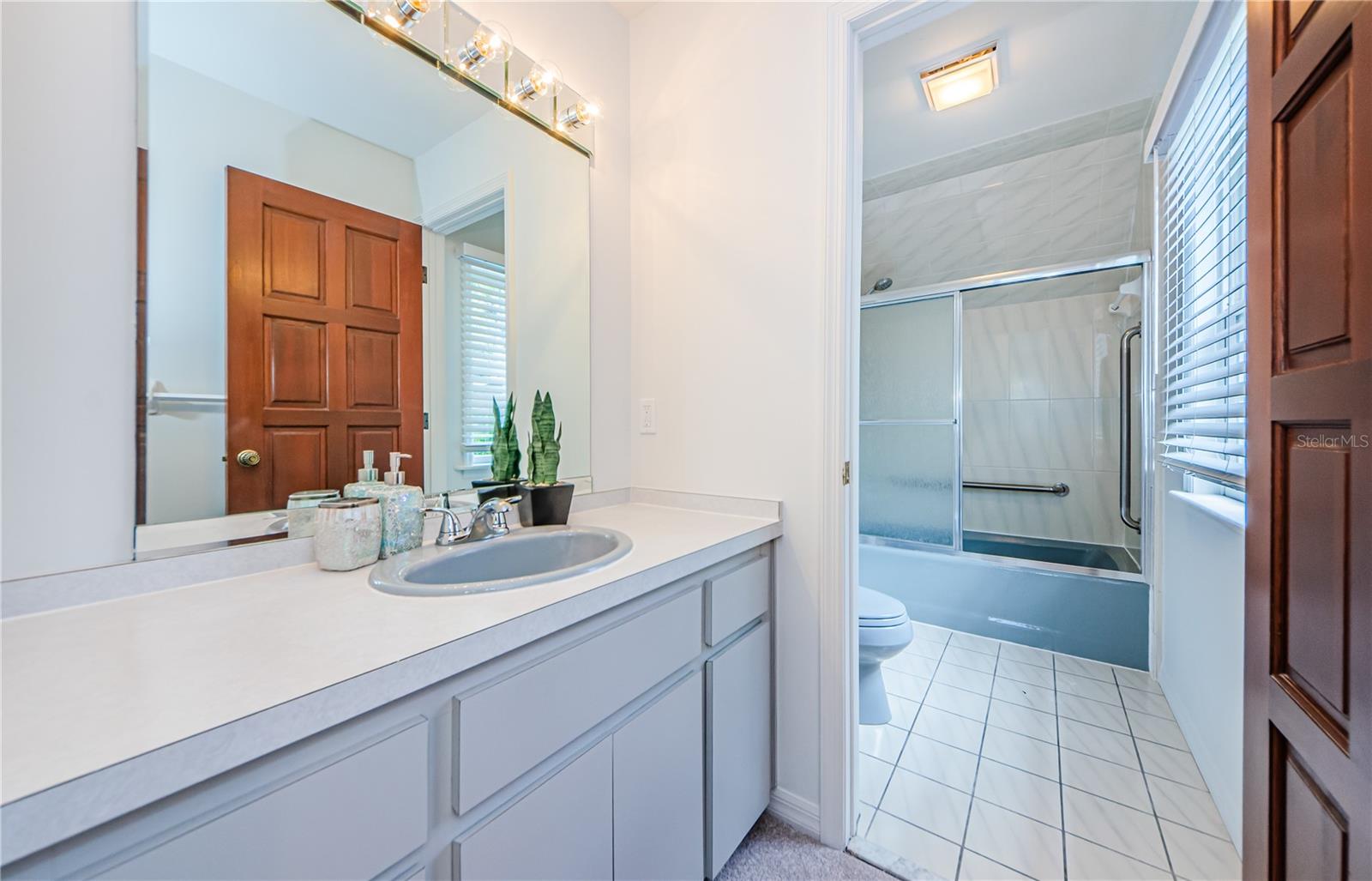 This is an ensuite bathroom to the furthest bedroom down the hallway on upper level.