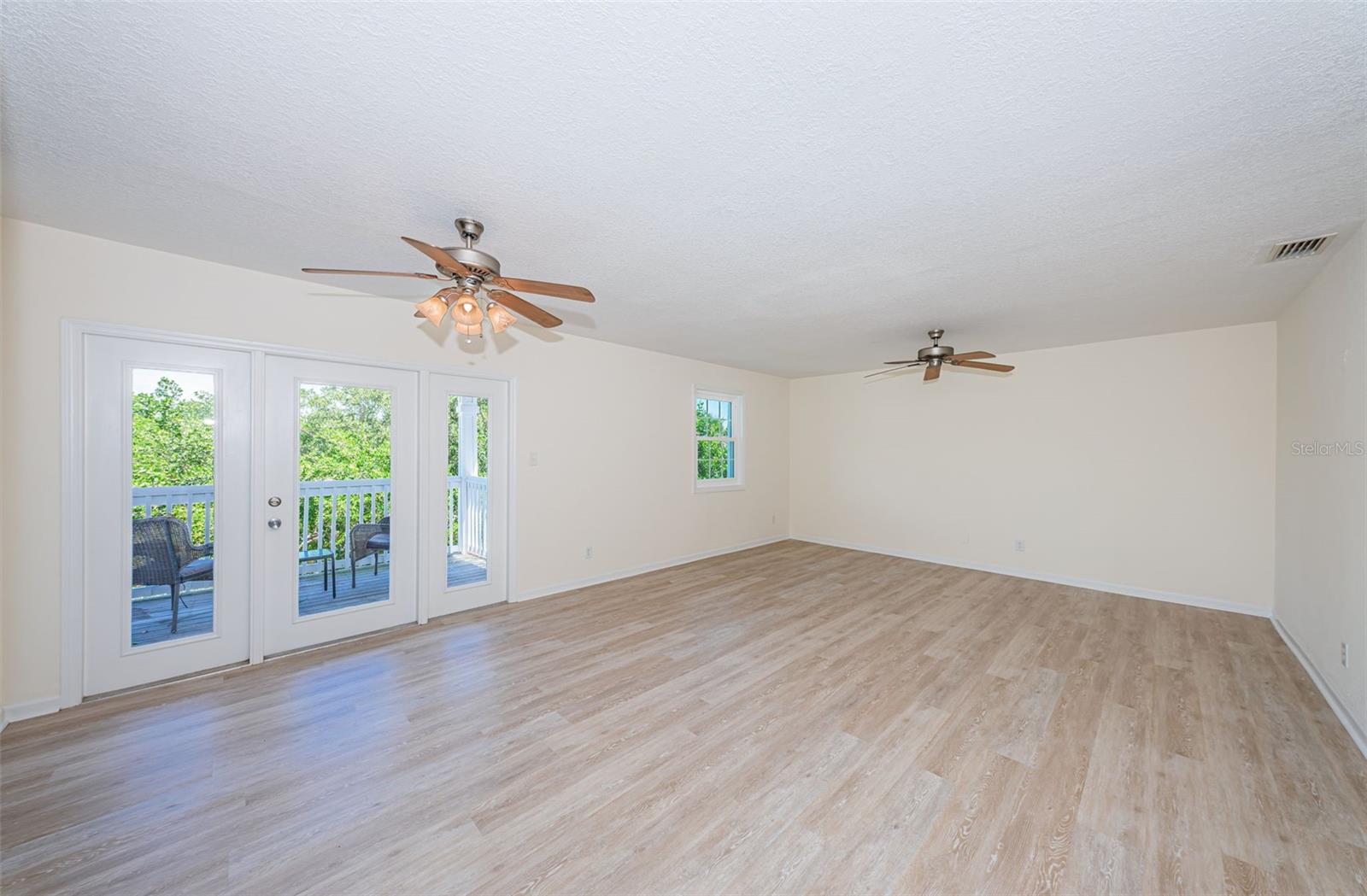 Gorgeous French doors lead to the breezy balcony and bring the outdoors inside to the bright open living room. New LVT floors, new windows, freshly painted ... move right in!