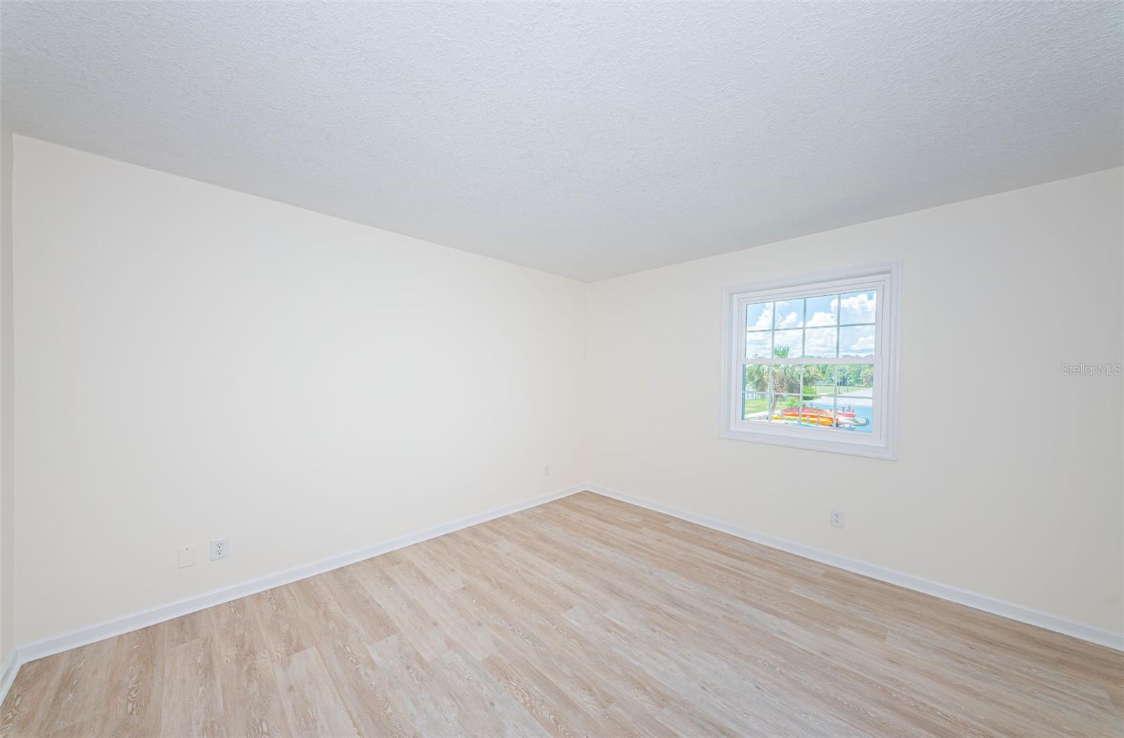 Primary bedroom has new windows, fresh paint, new LVT floors, a walk in closet and en suite bath.