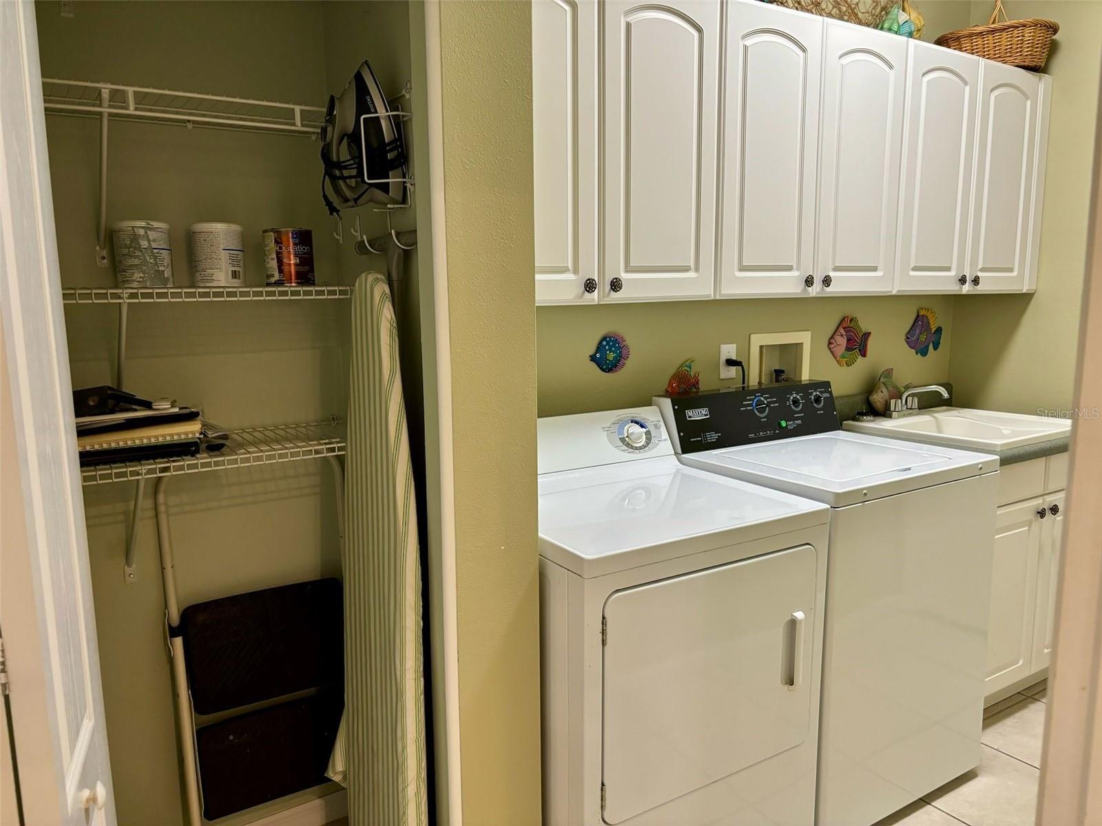 Laundry room with closet, cabinets, newer washer/dryer and sink