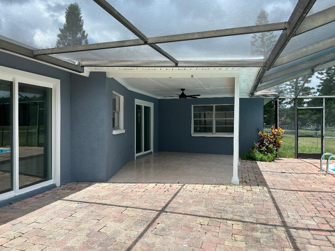 Covered area with recessed lights and beadboard ceiling, fan