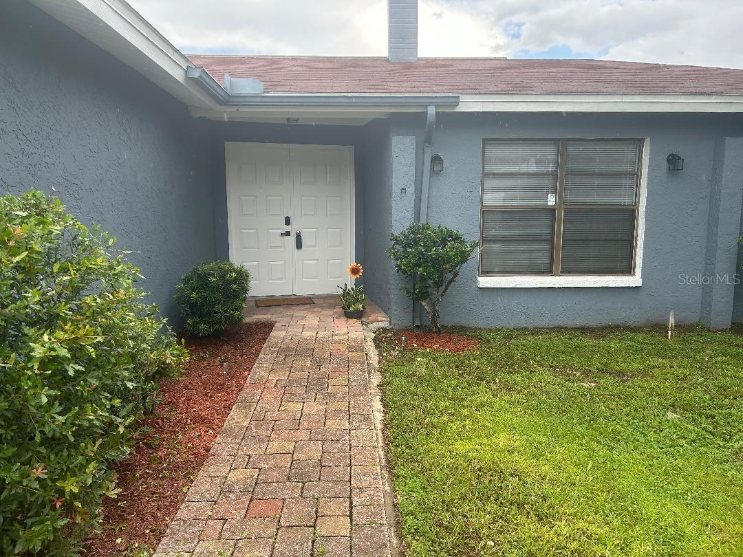 Paved walkway from driveway to front entry