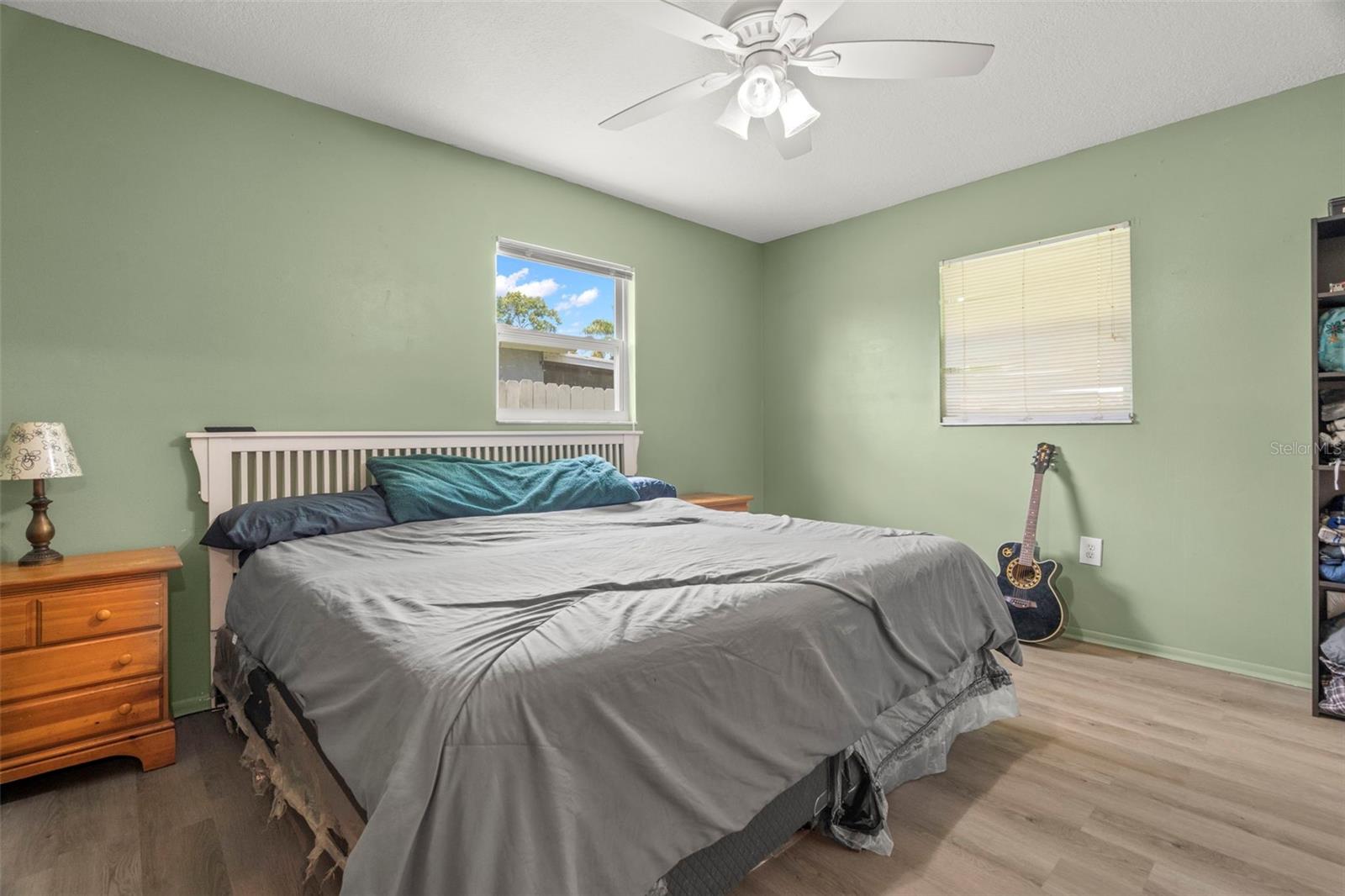 Master Bedroom, one window looks out into the backyard, the other into the screened porch.