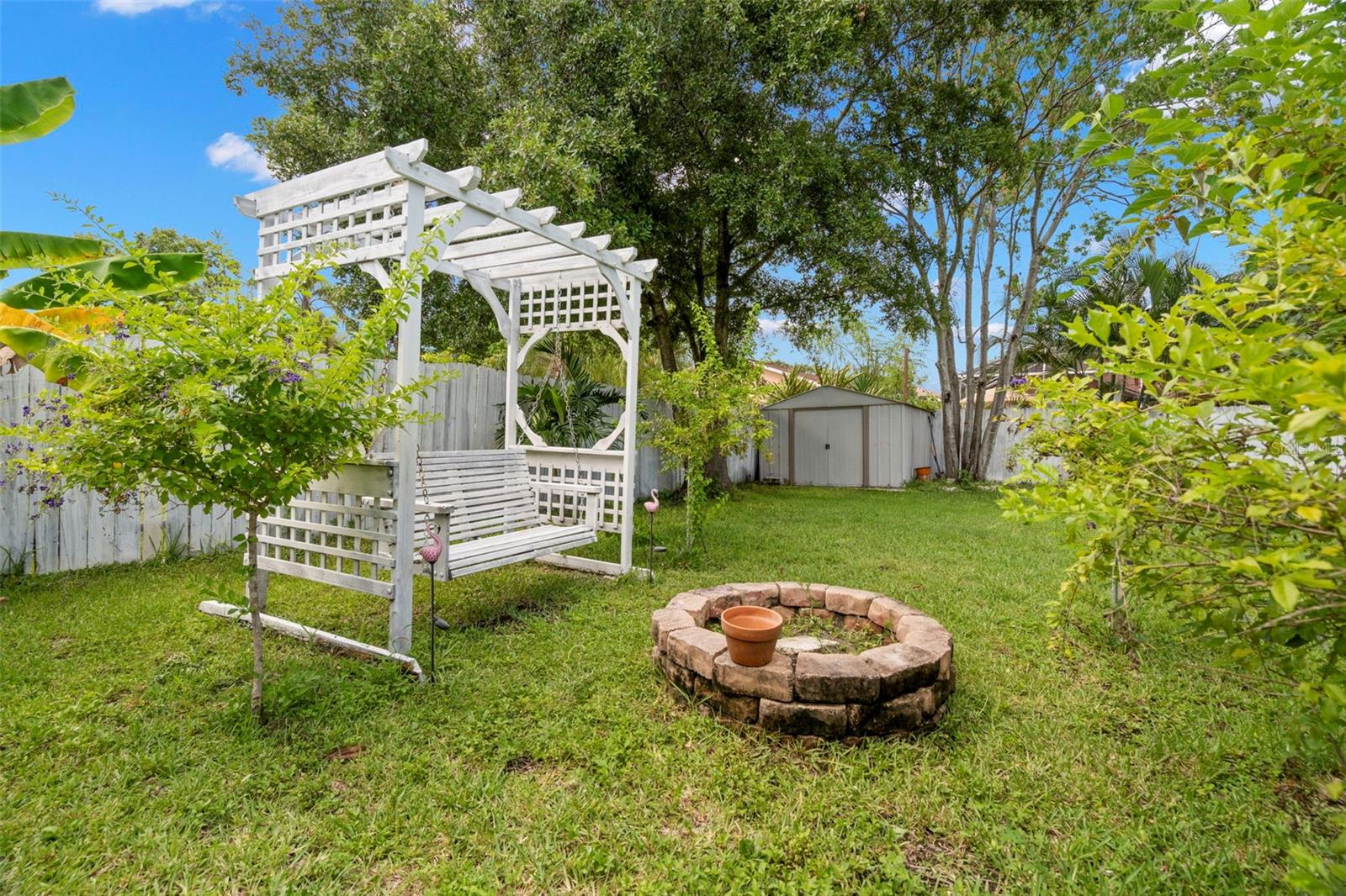 Swing, fire pit, and shed