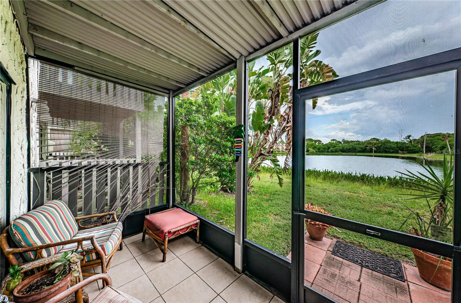 Outdoor screened in lanai with pond view