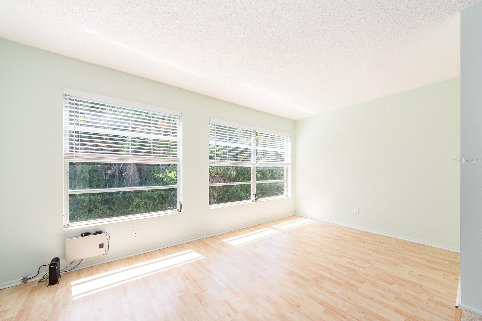 LARGE SUNROOM WITH VIEW OF GREENSPACE