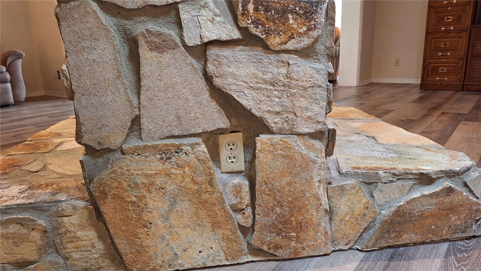 Fireplace equipped with electrical outlet