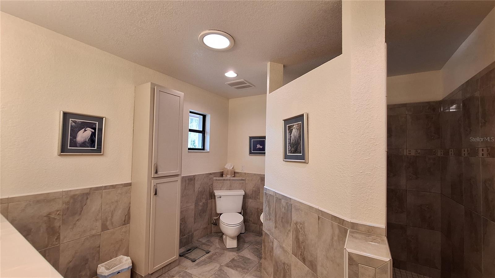 You'll love the large walk-in shower and additional cabinetry for linens