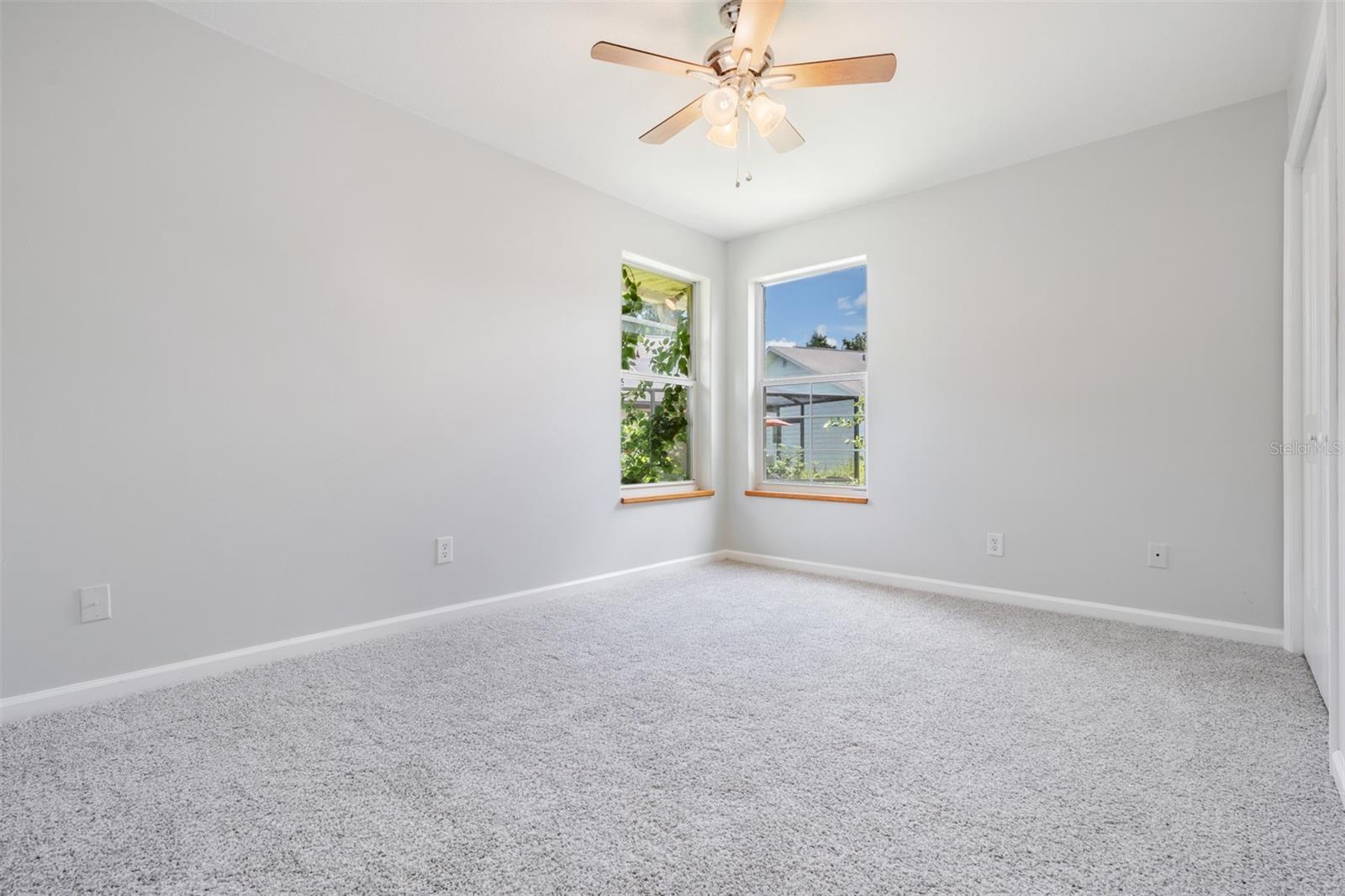 2nd bedroom with corner window for a Great spot to read with natural light!