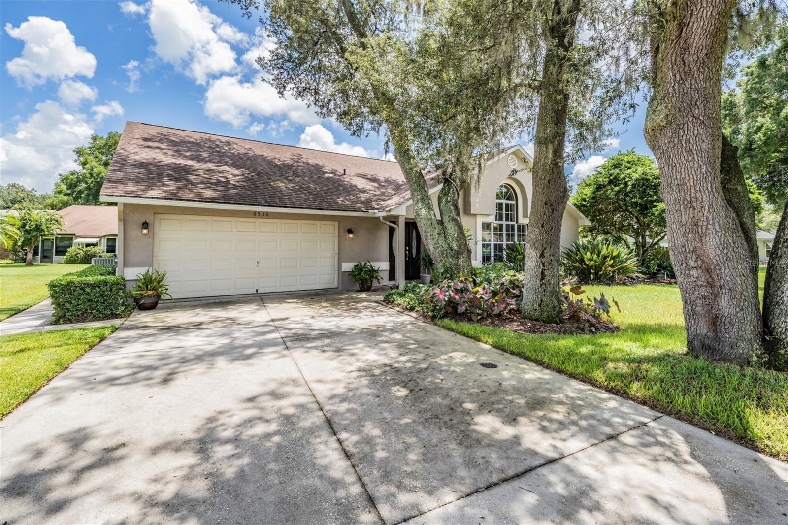 Plenty of parking with sidewalk to side garage door