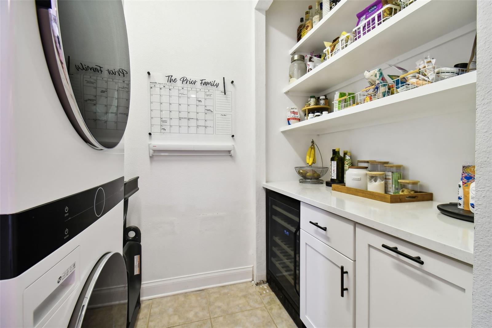 Custom walk-in pantry with new stackable LG washer and dryer