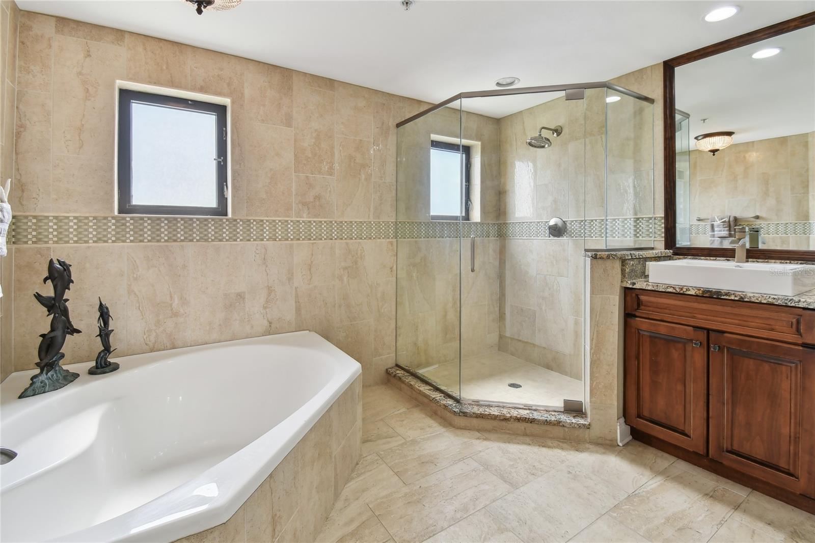 The Owner's Bath with garden tub, walk in shower and custom vanity