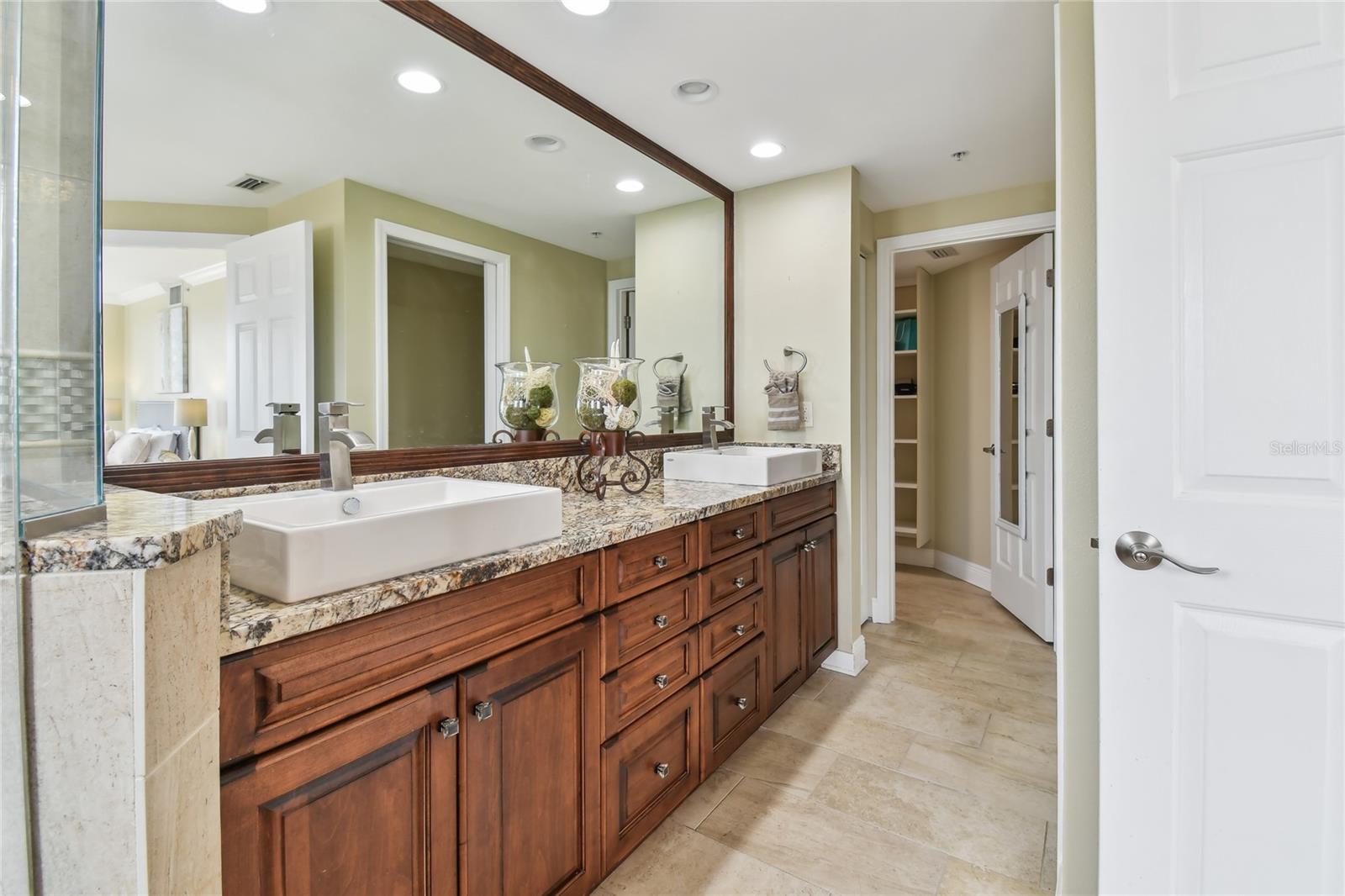 Owner's vanity with vessel sinks and plenty of cabinets and drawers