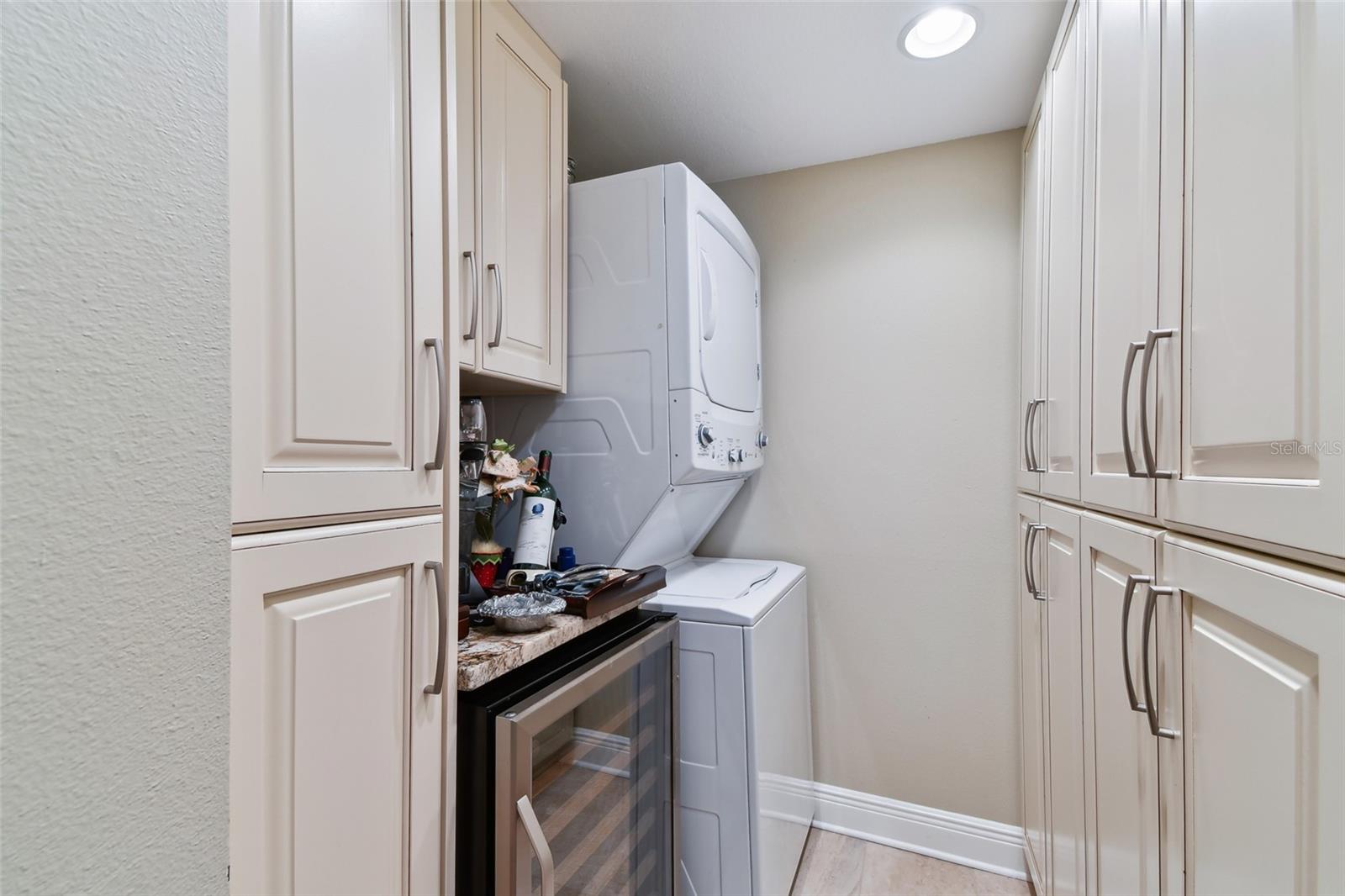 Laundry Room has custom cabinets and wine cooler