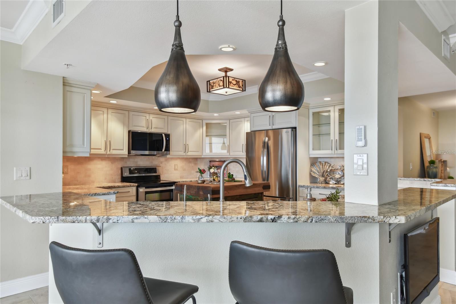 Glass cabinets, soft close drawers and pullouts, features of the Kitchen