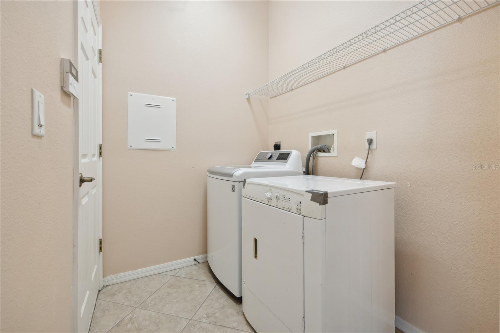 Laundry room off the kitchen leading to garage