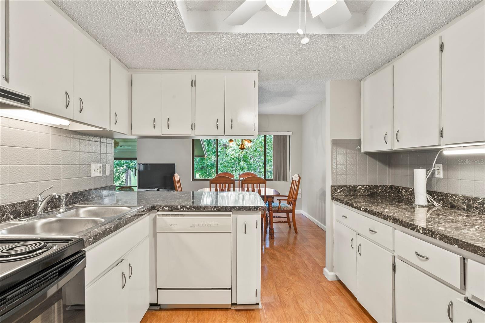 Kitchen has a double stainless sink, dishwasher and range.