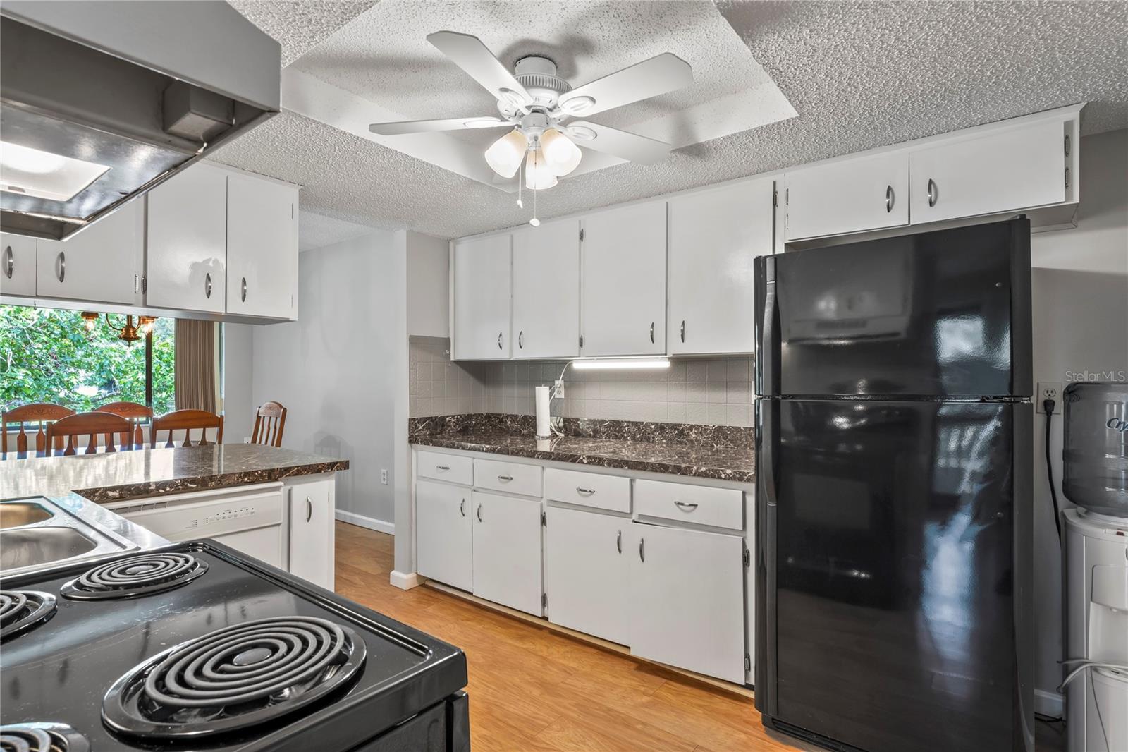 Refrigerator and ceiling fan, lots of counter space.