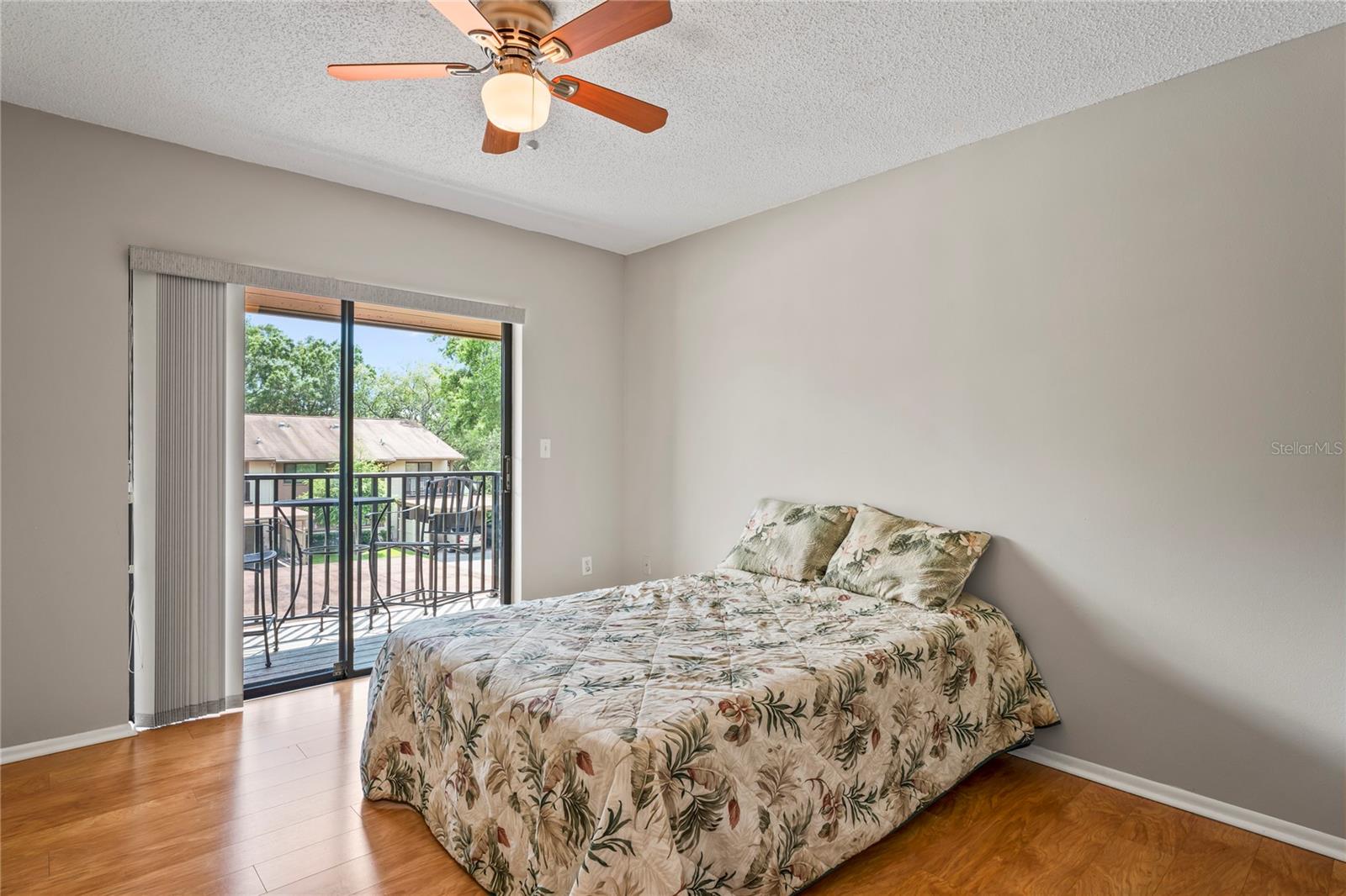 Guest bedroom has a sliding glass door leading onto the balcony.