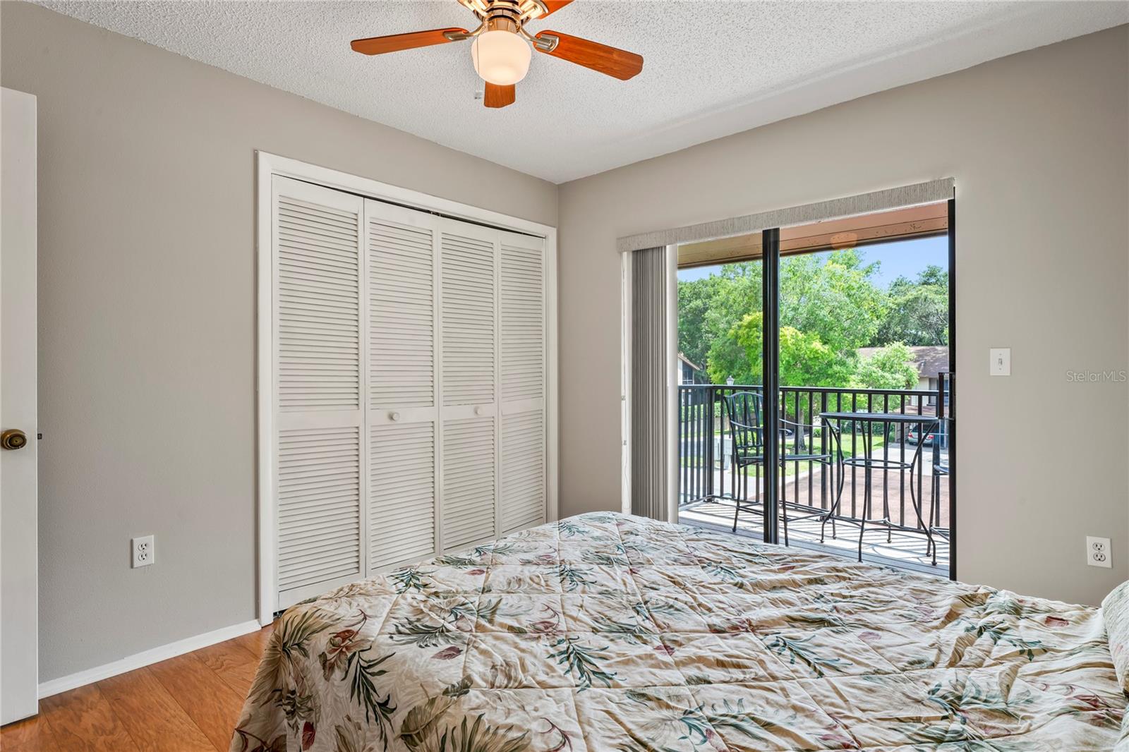 Double closet, laminate flooring, ceiling fan and balcony.