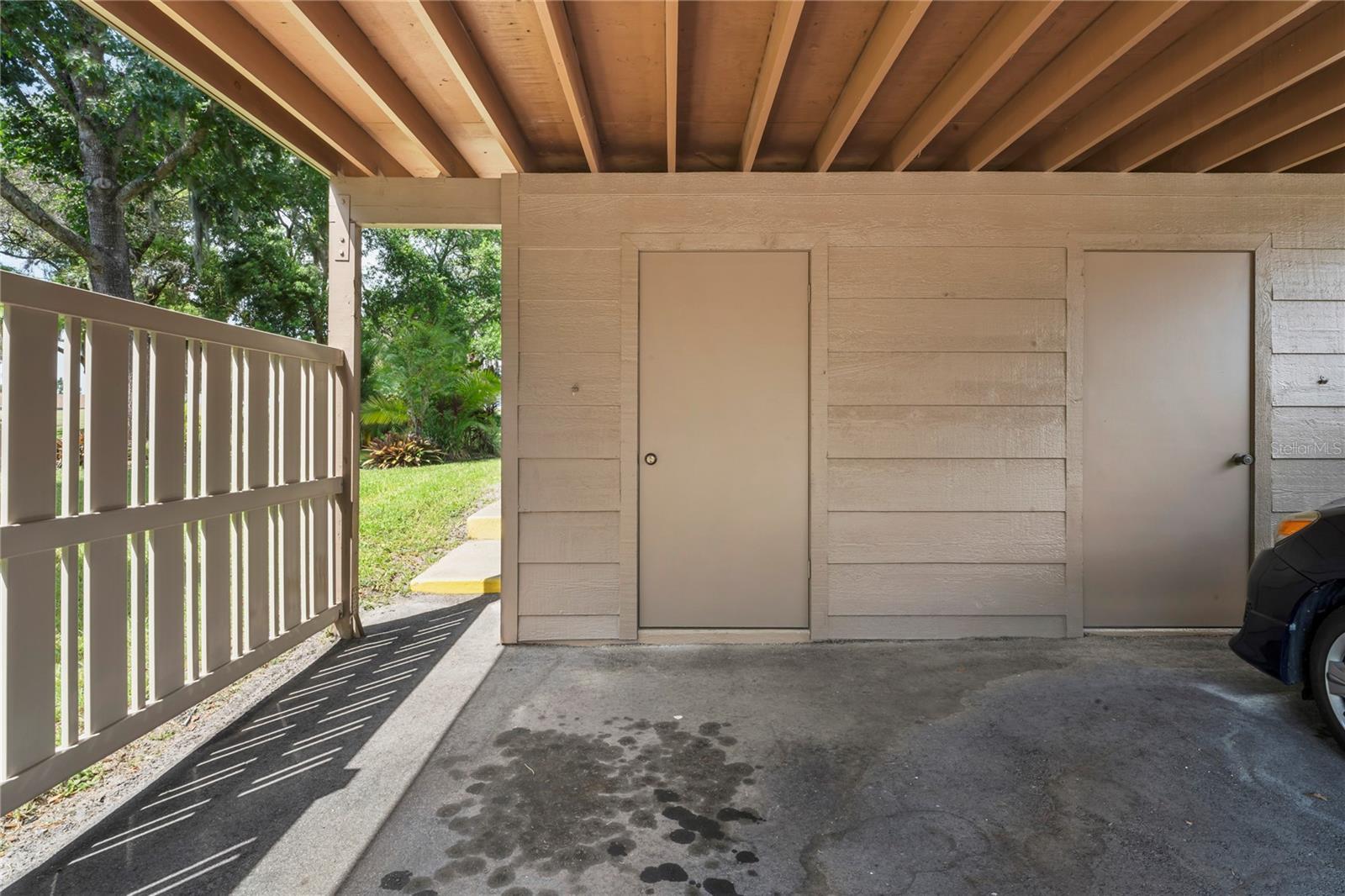 Closer view of the storage shed and carport.