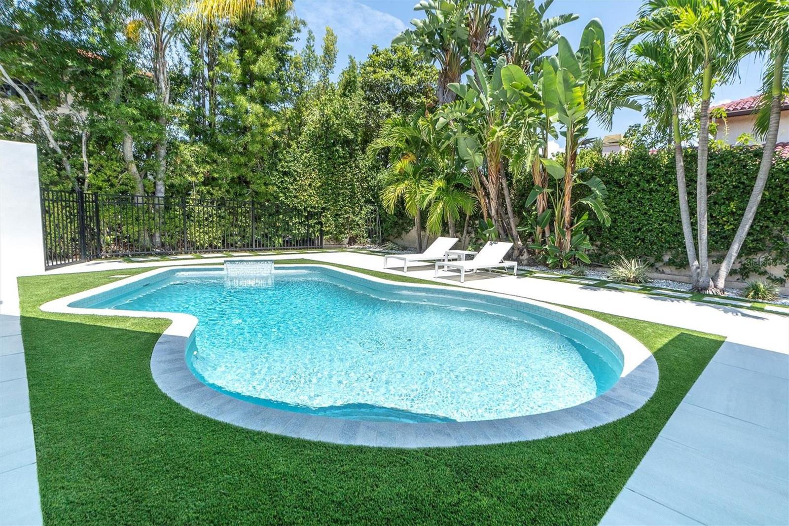 Privacy wall with lush tropical landscaping