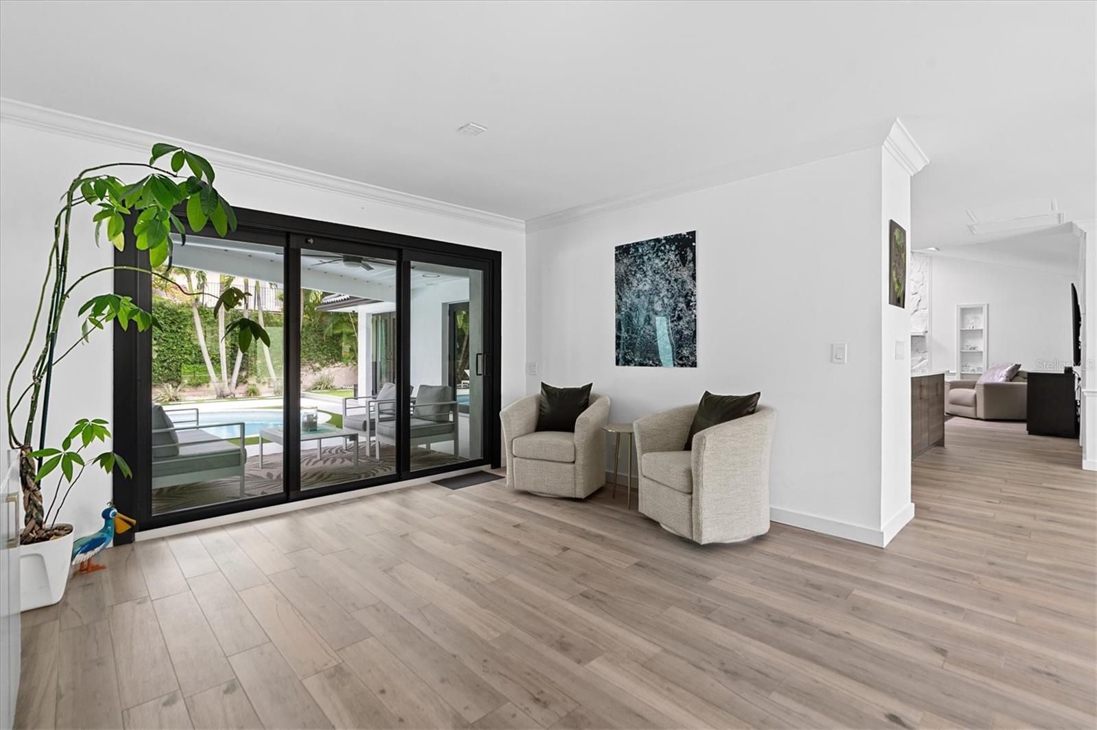 Sliding doors lead you to a tropical pool oasis!