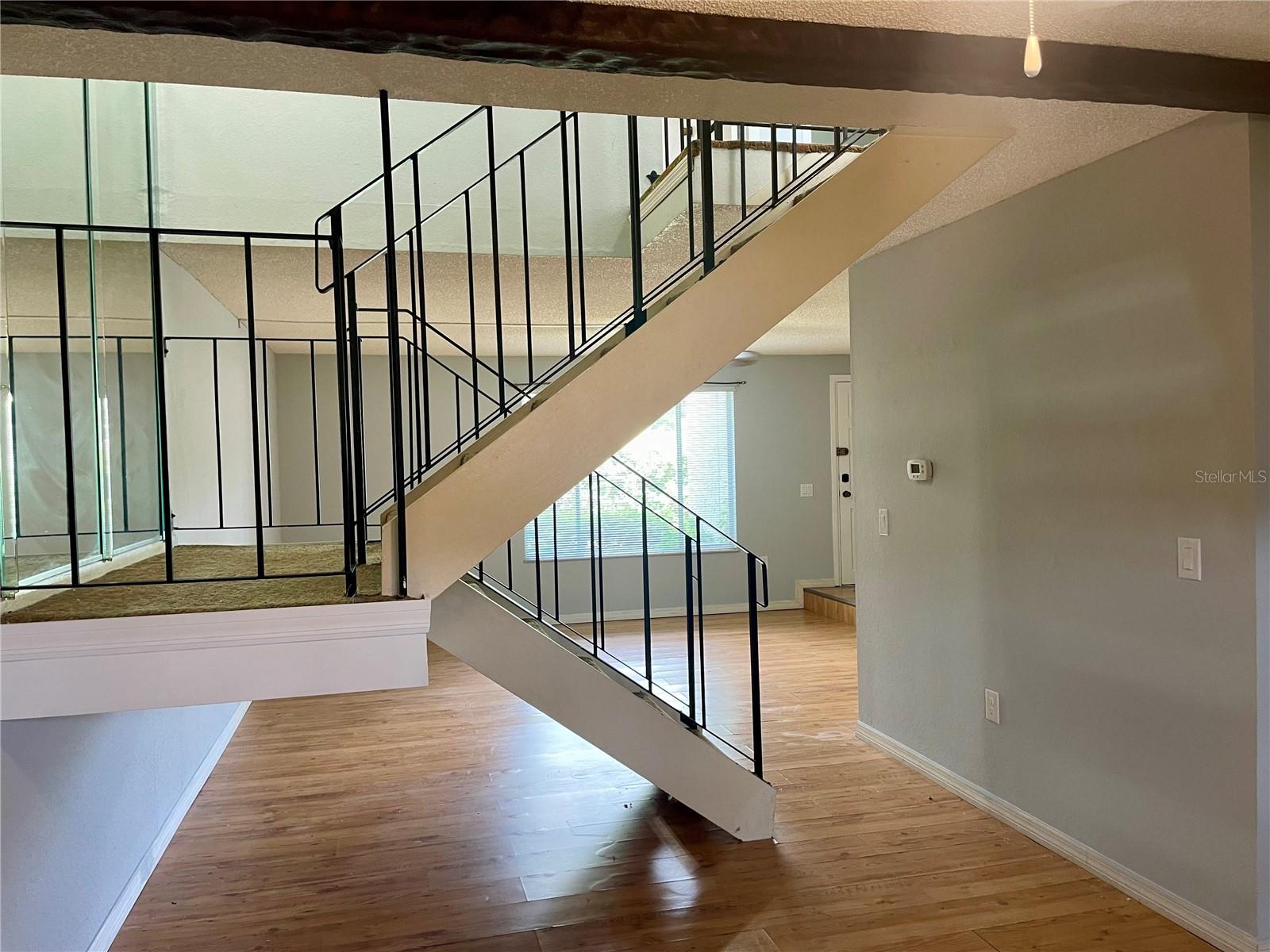 looking past stairway to living area