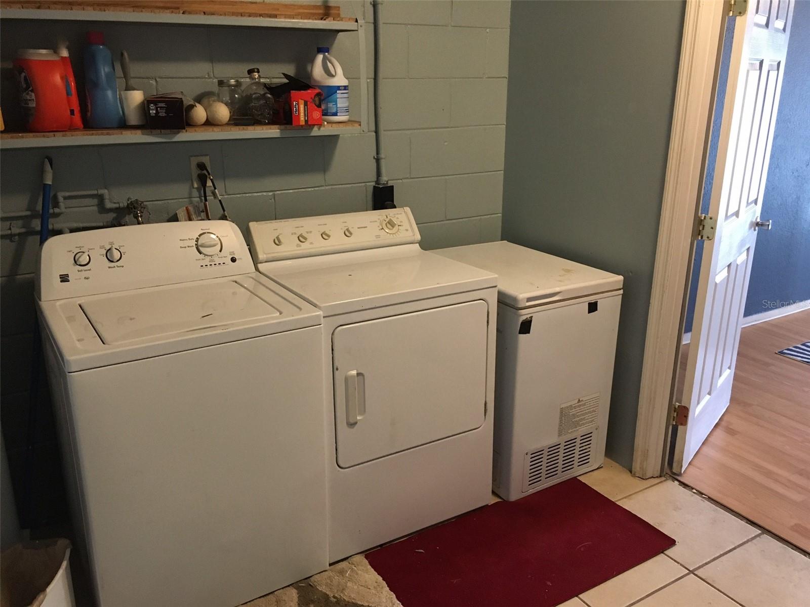 Laundry room showing door to bonus room